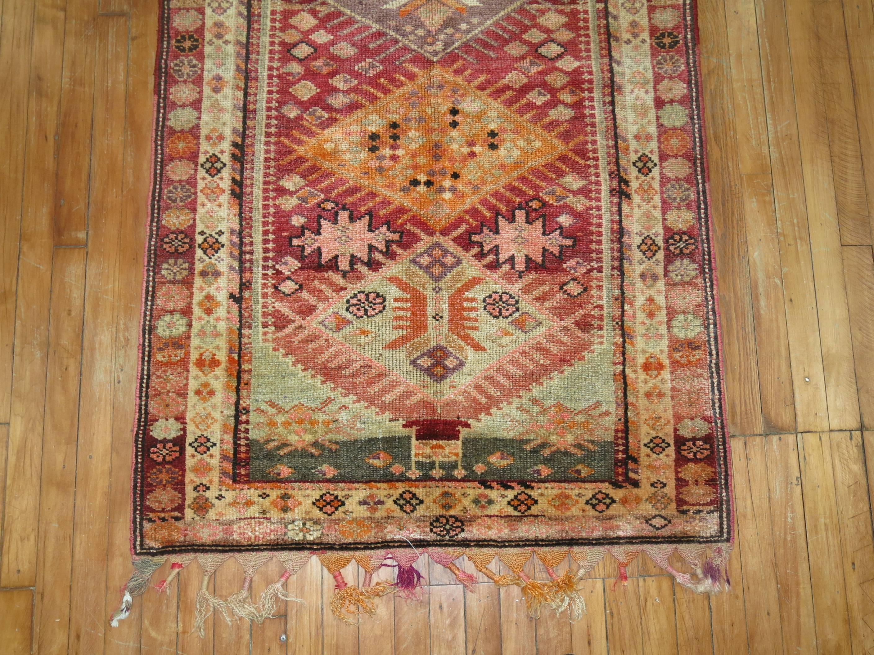 One of a kind Turkish Anatolian runner with a triangular geometric motif throughout in bright colors on a blood red color ground.

Measures: 3'3