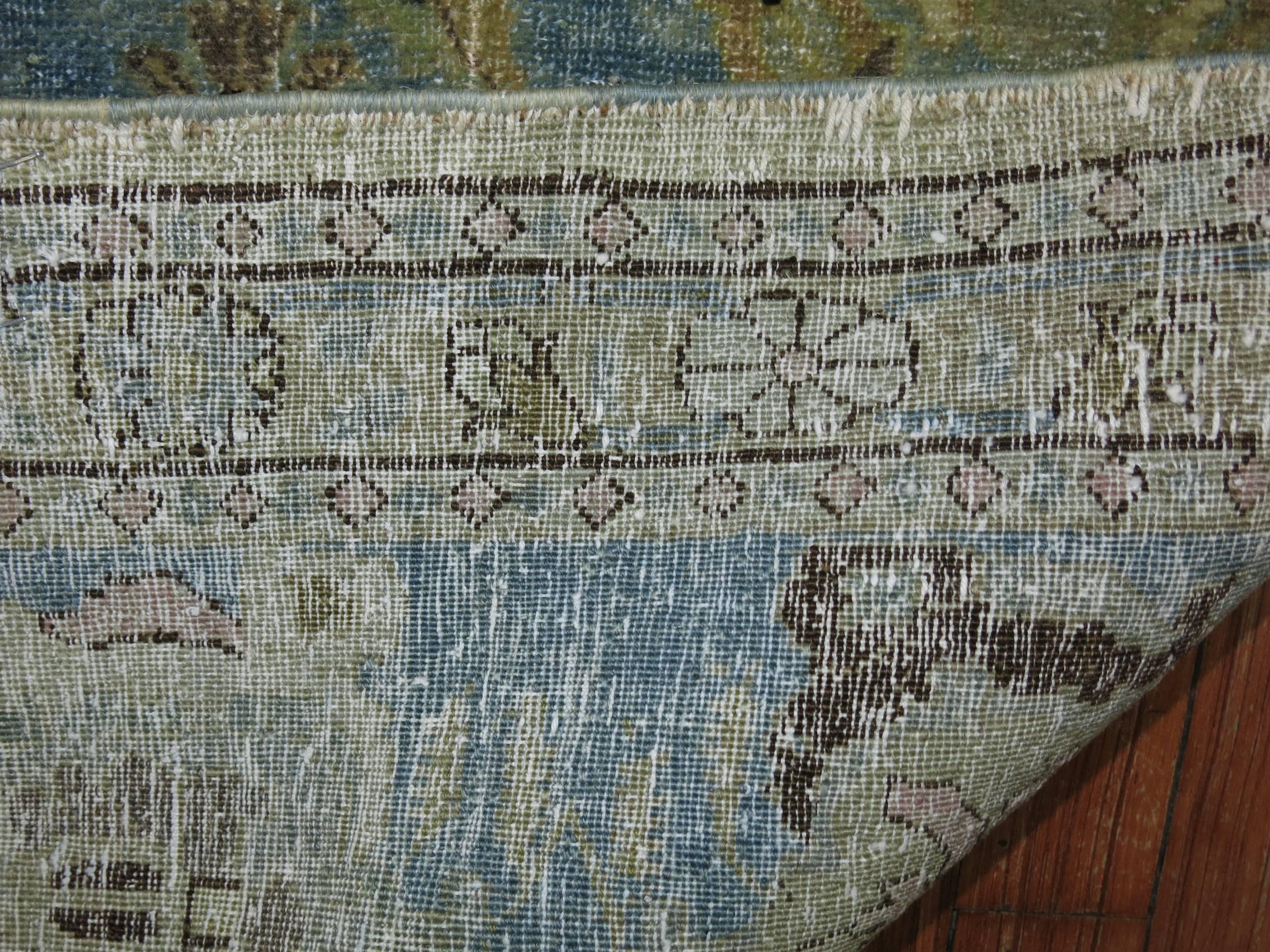 Early 20th century Persian Tabriz carpet in predominant sky blue tones. Accents in green and brown.

Although extremely difficult to procure because of their limited production and great demand, a small number of Tabriz carpets can still be found