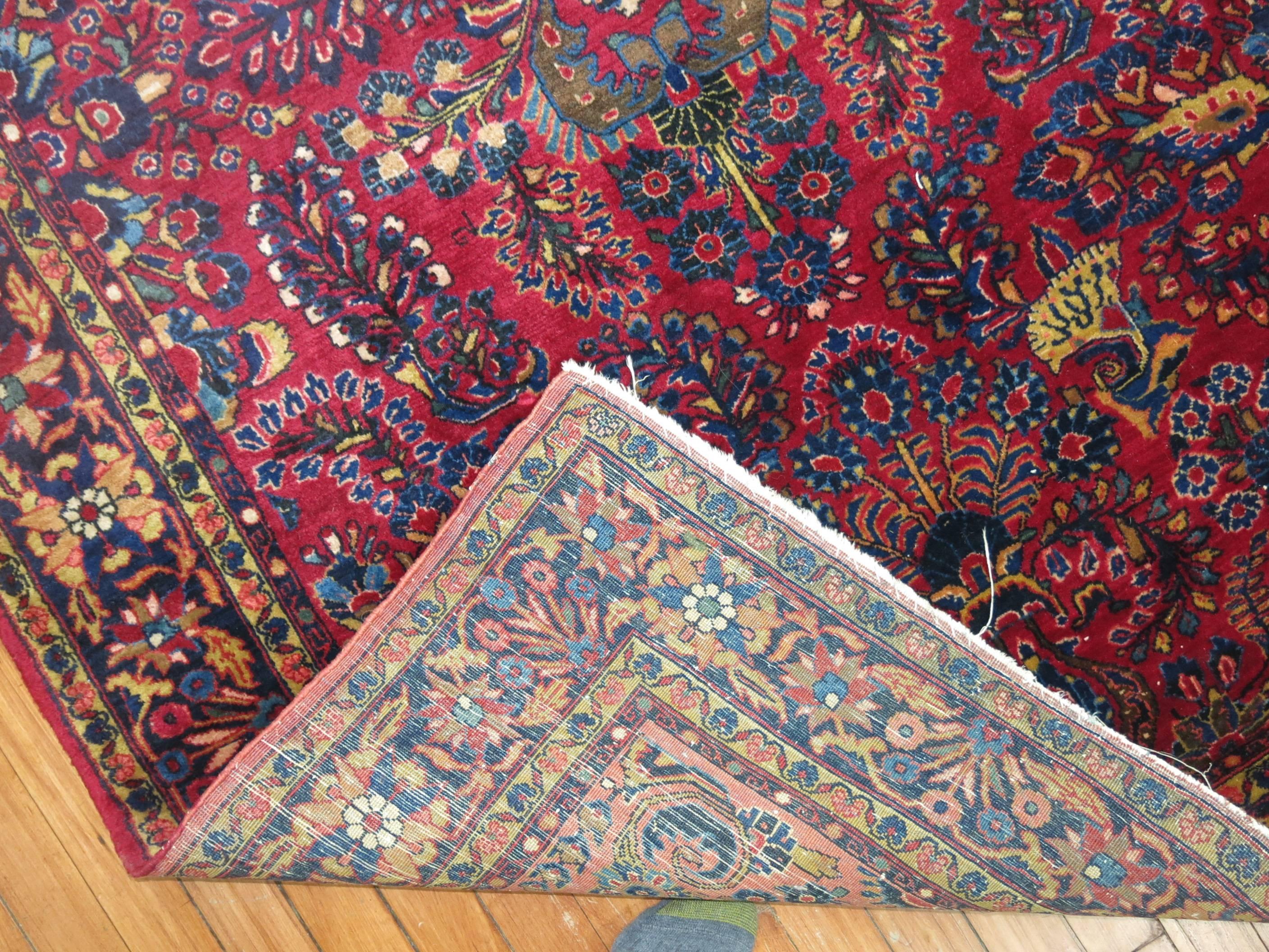 An early 20th century antique Persian Sarouk rug in deep reds and blues.

Sarouk rugs have been produced for much of the 20th century. The early successes of the Sarouk rug are largely owed to the American market. From the 1910s-1950s, the