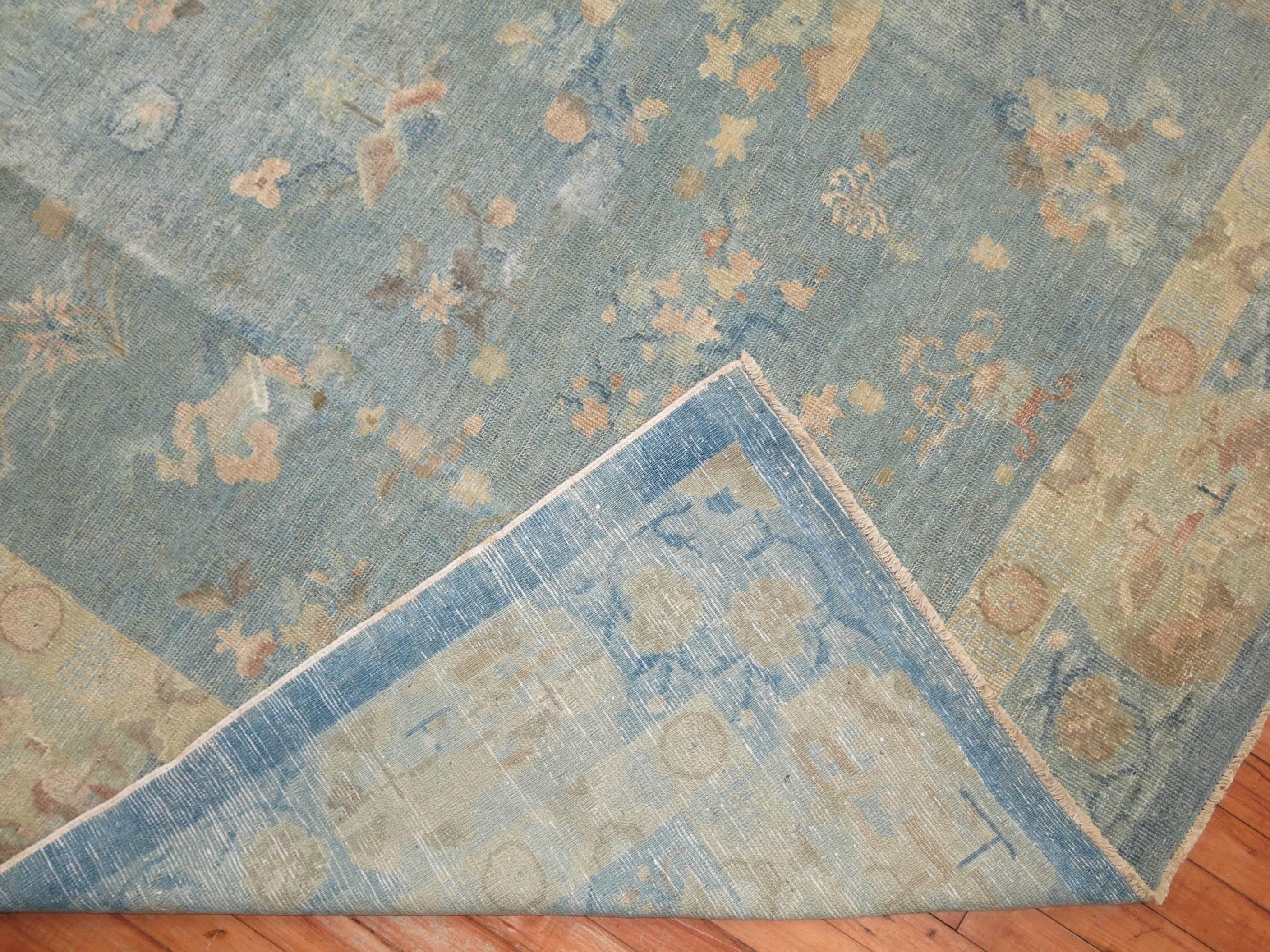 An antique Chinese Peking rug in soft blues and creams with a elegant floral design throughout.  Even thin Pile throughout. Great quality and texture. Soft on the Feet

8' x 9'8''

Antique Chinese carpets have a very long and distinguished history
