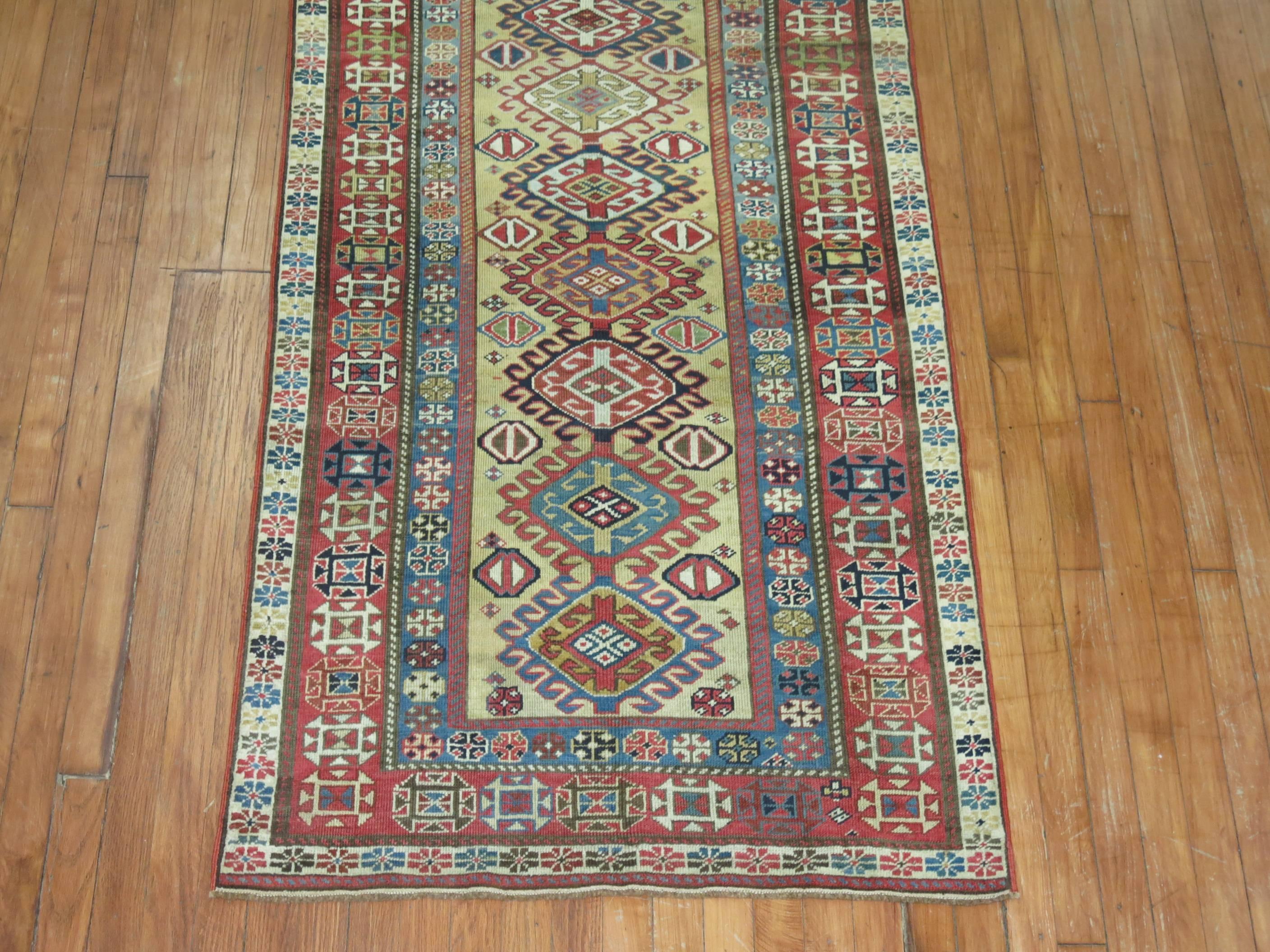 A rare size Caucasian runner with a camel field, accents in green, red, blue.

Measures: 3'1'' x 8'3''

Older Caucasian antique tribal carpets are all wool not only the knotted pile, but the warp and weft threads are usually made from hand-spun