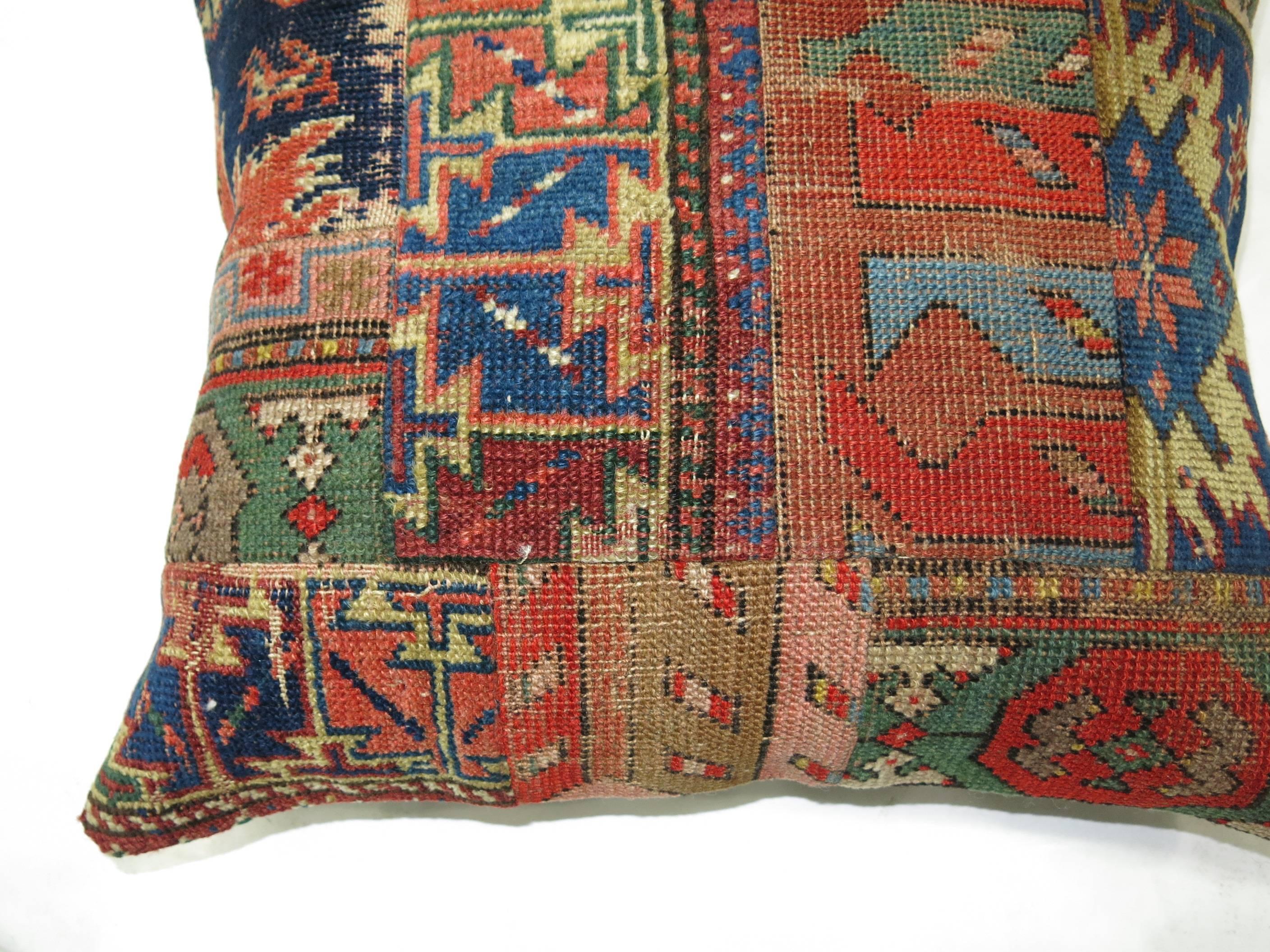 Pillow made from an assortment of antique Persian and tribal Caucasian rugs.