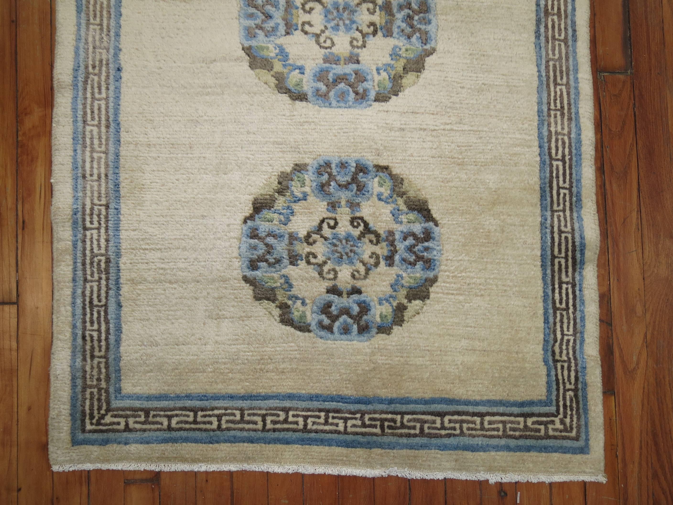 A full pile Tibetan throw rug in clear white and blue hues,

circa 1930, measures: 2'11