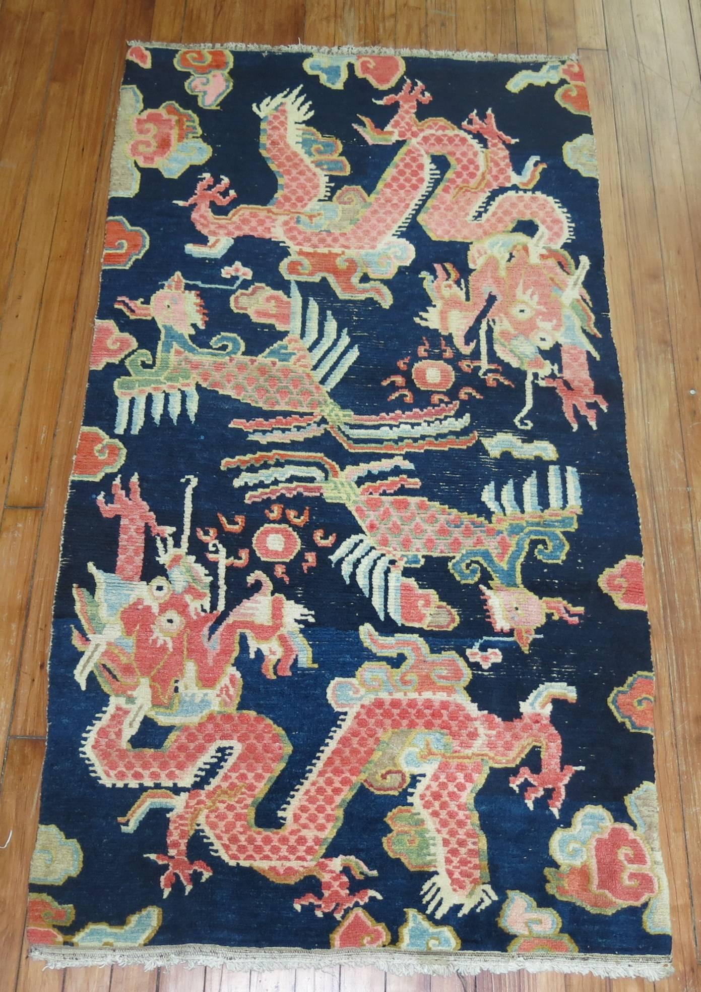 An antique tibetan rug with a dragon niche motif on a navy blue ground.

Tibetan rug making is an ancient, traditional craft. Tibetan rugs are traditionally made from Tibetan highland sheep's wool, called changpel. Tibetans use rugs for many