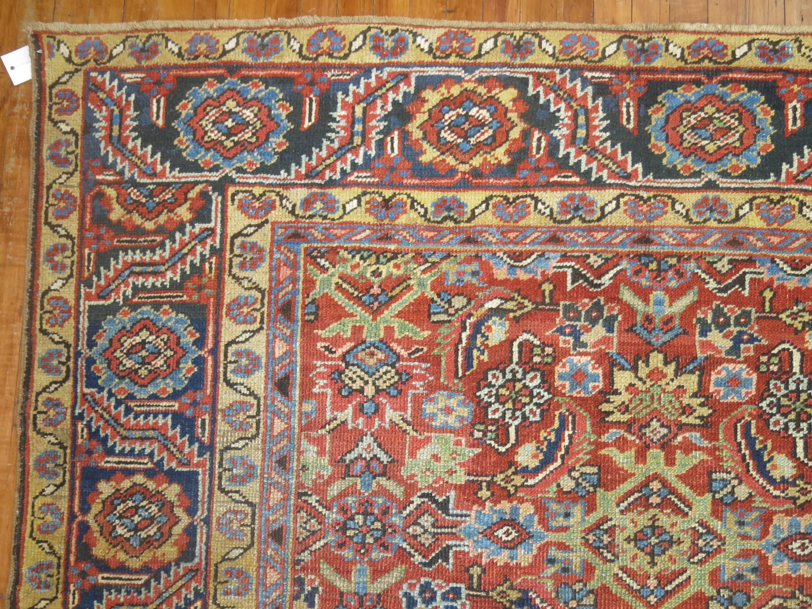 An all-over traditional herati design decorative Persian Heriz rug on an orange field and navy border. Colors in light green, light blue and pink accents.

Measures: 9'3