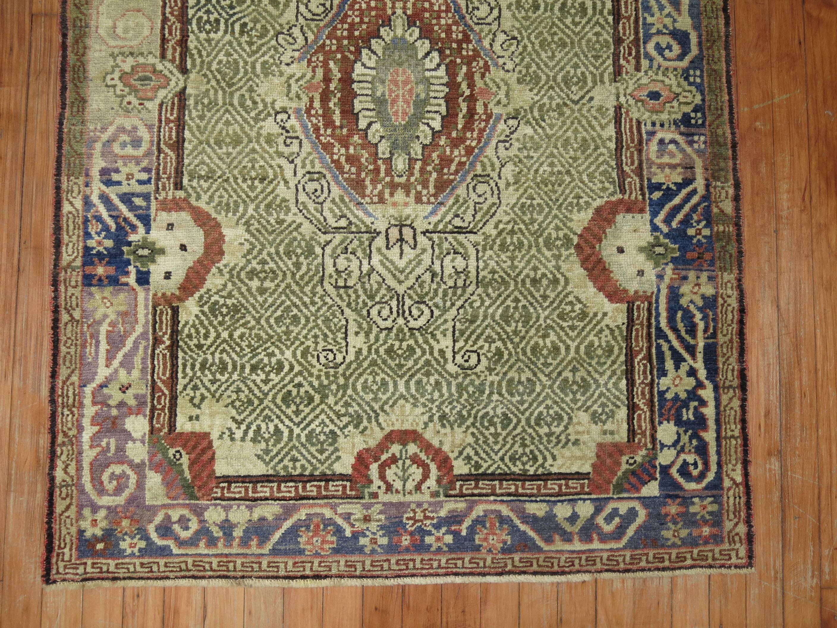 A Turkigh Ghiordes knot rug in predominant earth shades in brown, blue and green.