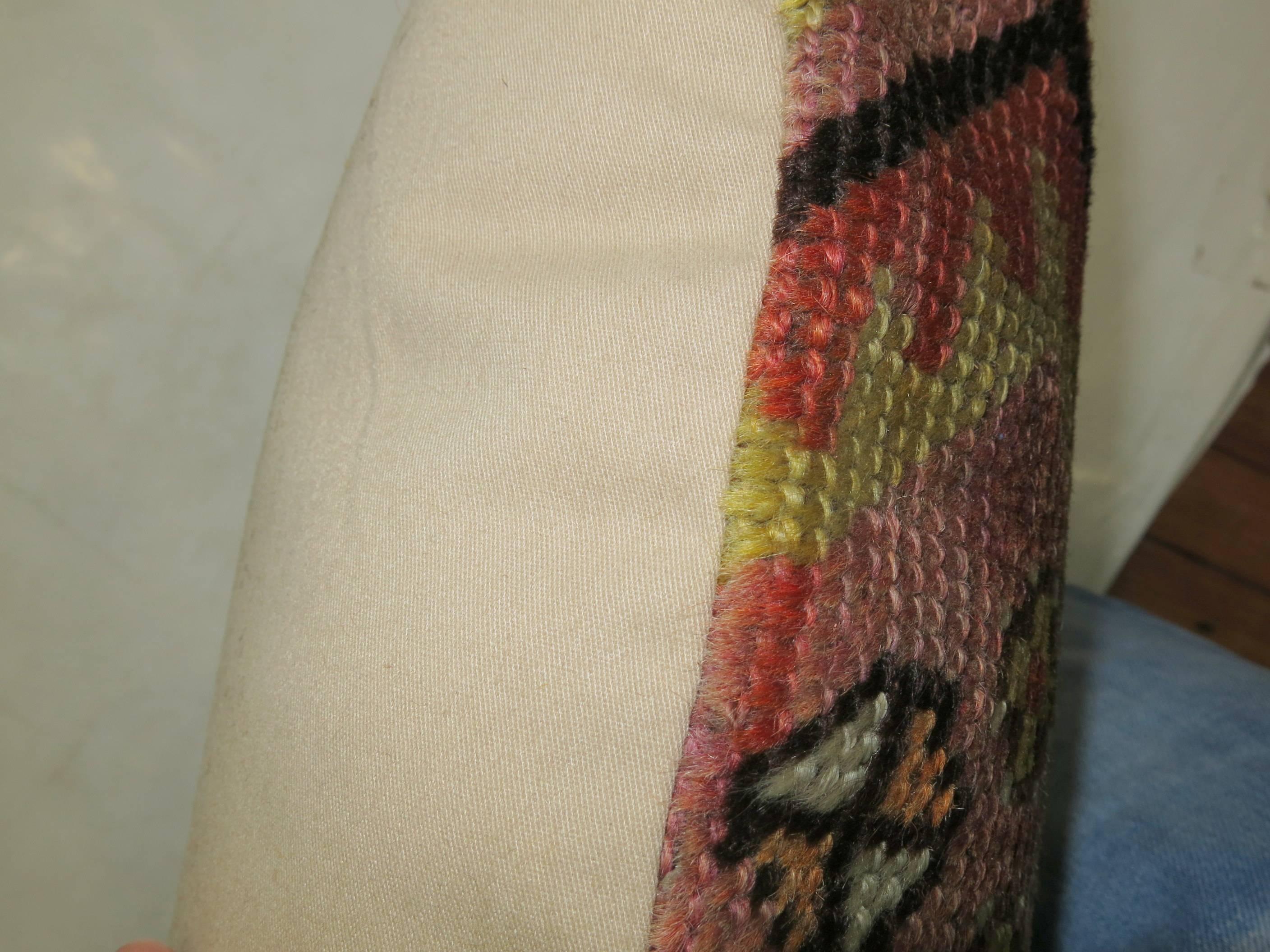 Pillow made from a Turkish rug with a primitive design on a soft pink field.

Measures: 15