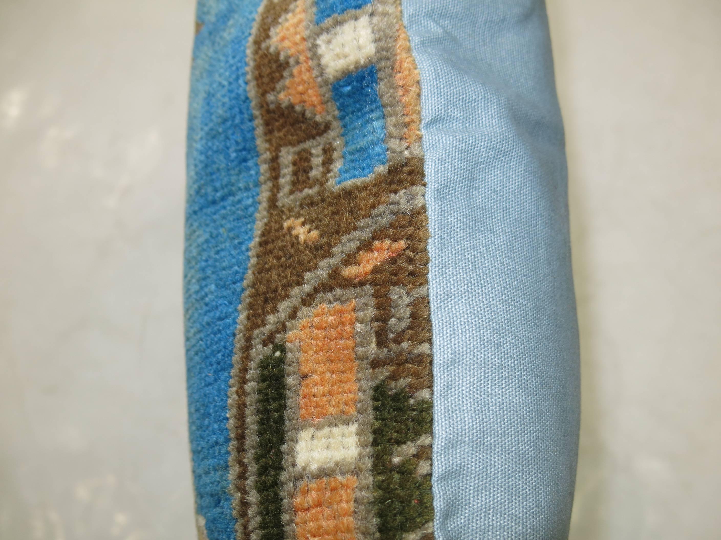 Pillow from a Turkish rug featuring a stunning blue tone.