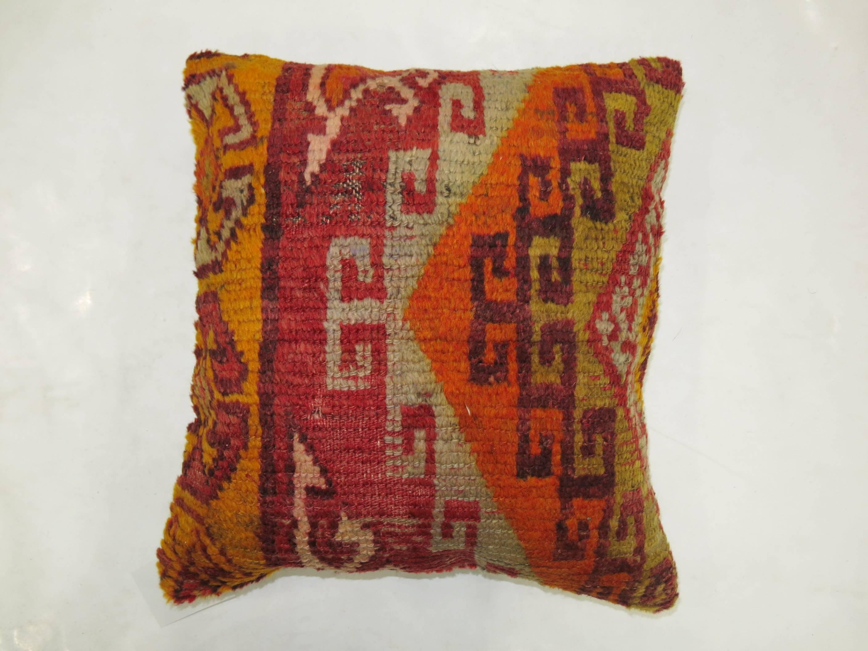 Pair of bright Turkish rug pillows measuring 16'' x 16'' respectively.