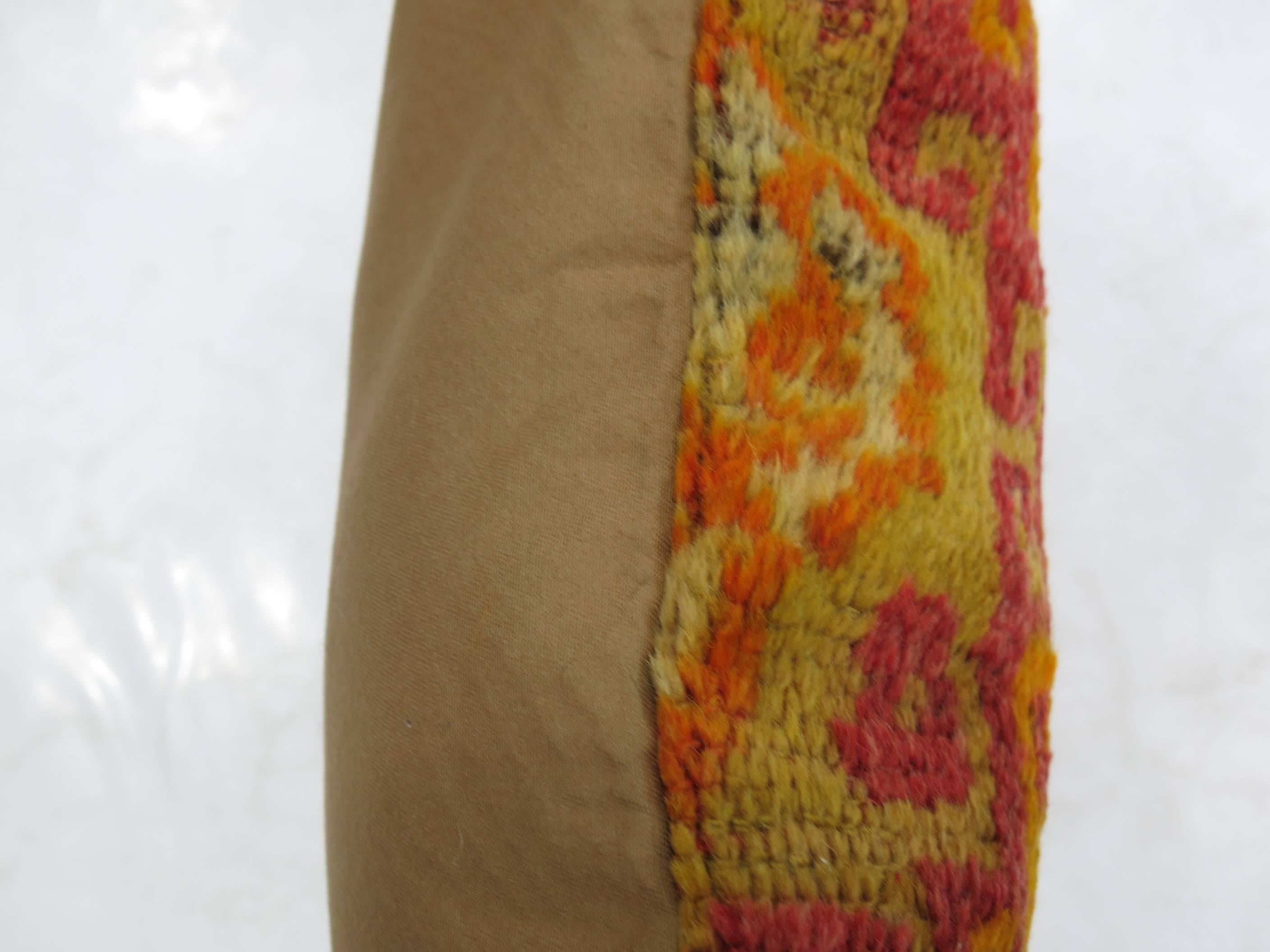 Pillow made from a vintage Turkish rug in bright red and orange accents.

12'' x 24''