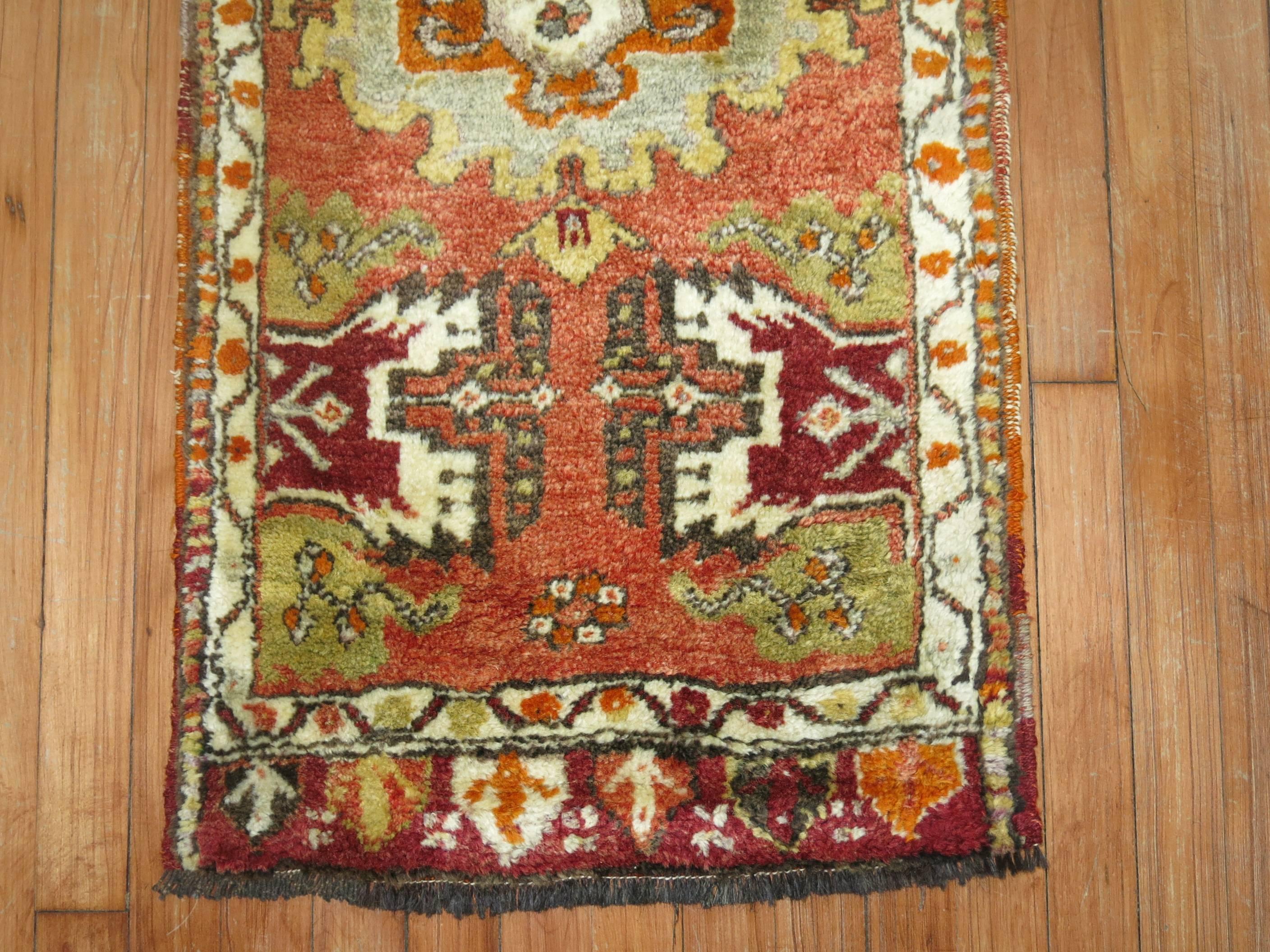 Vintage plush pile Turkish Yastik rug in predominant orange.