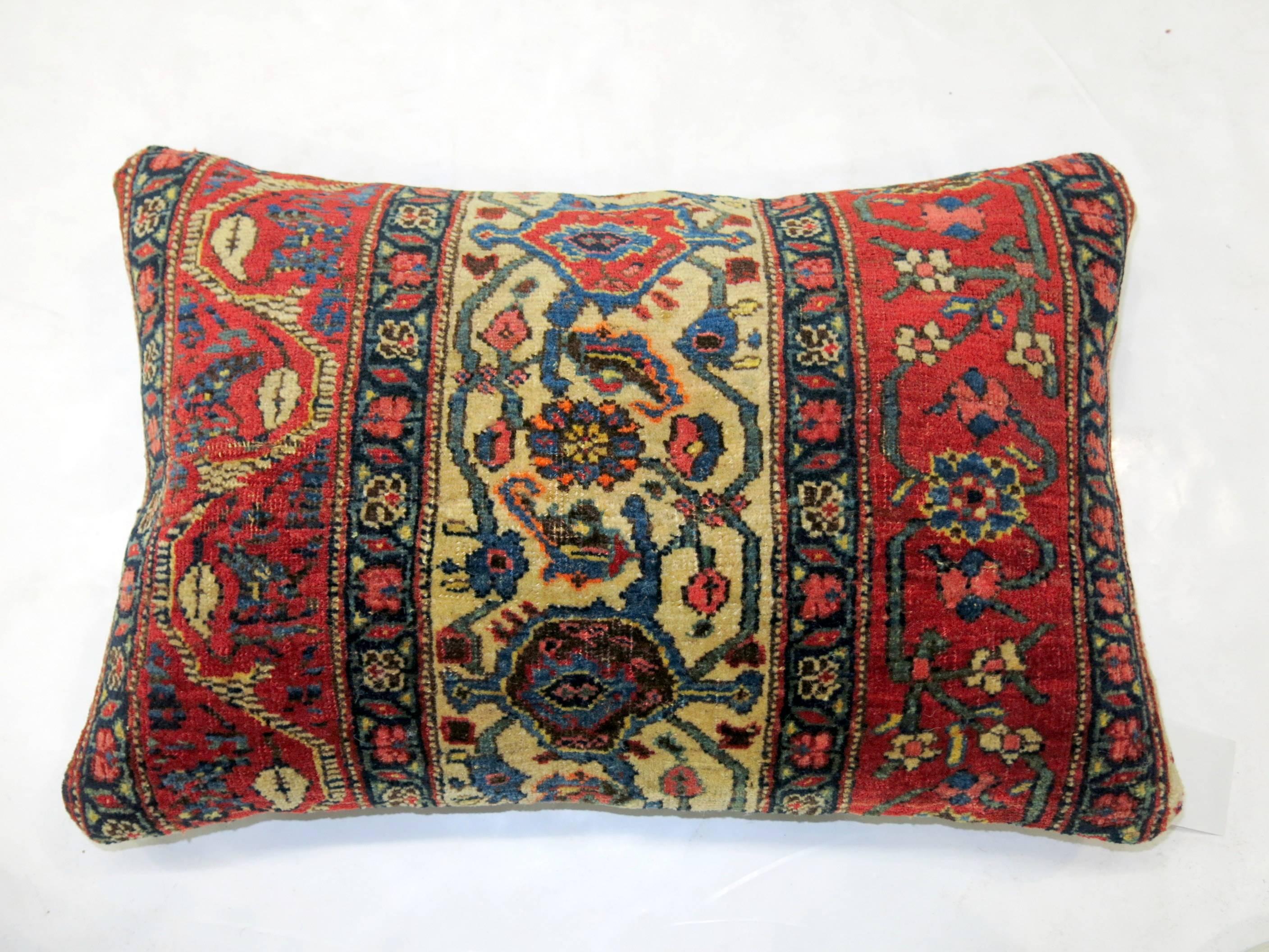 Pair of pillows made from an early 20th century Persian Bidjar rug with blue cotton backing. Each pillow measures 16” x 24”.