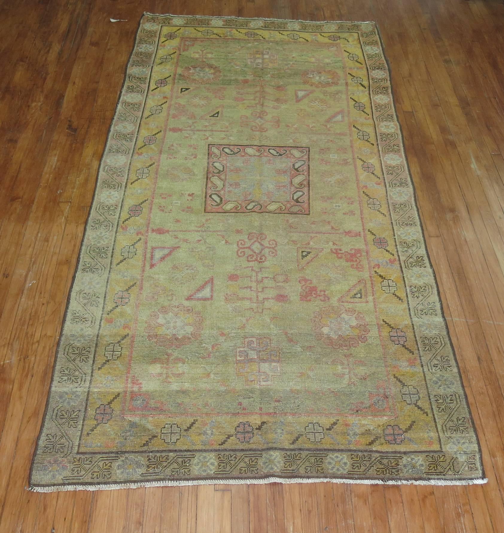 Antique Khotan rug with soft green field.

Measures: 5'2