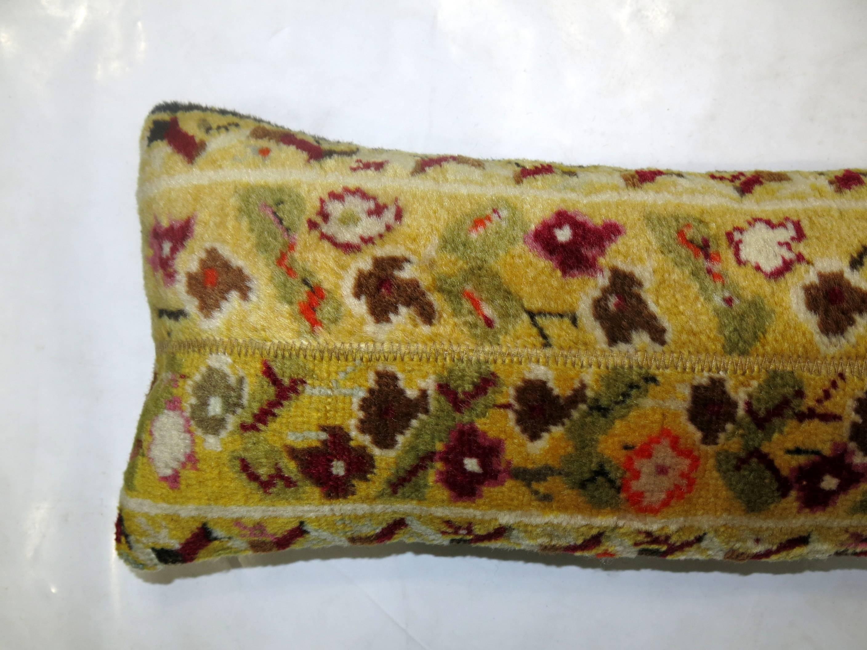Pillow made from a 20th century Turkish Ghiordes rug with a yellow field and floral design

9'' x 22''