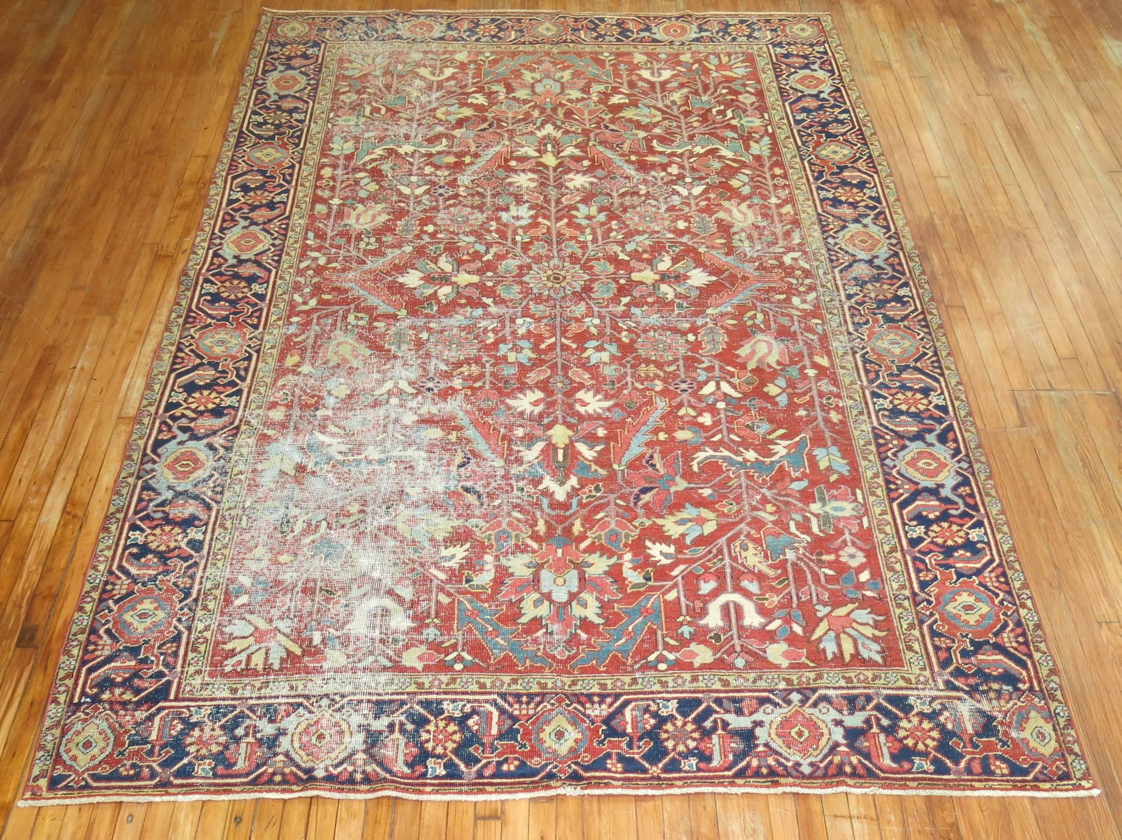 Room size early 20th century shabby chic Persian Heriz rug featuring an all-over design in cherry red.

Measures: 7'9
