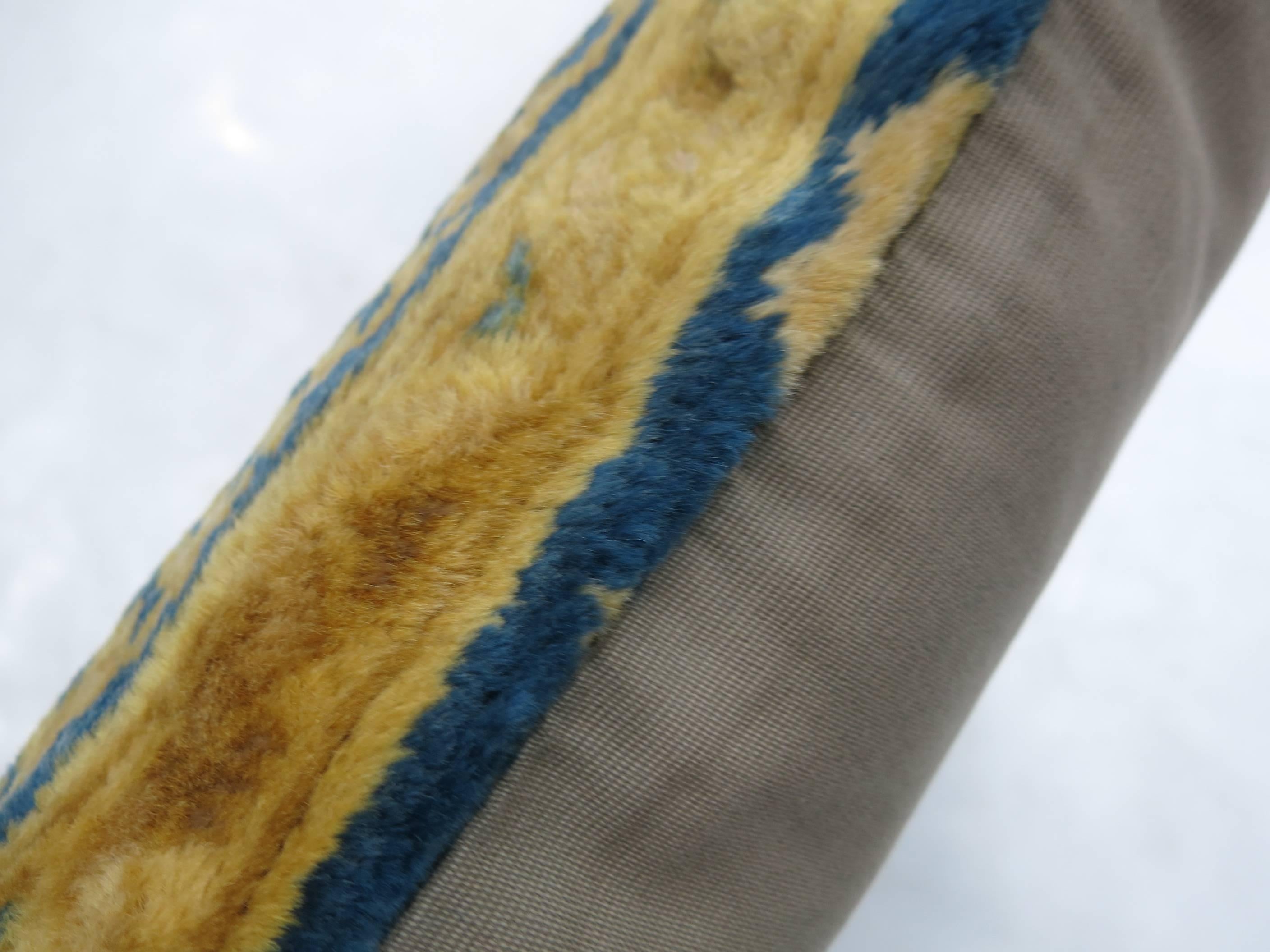 Pillow made from a stitched border of a 20th century Indian larestan rug with silky wool in blues and gold.