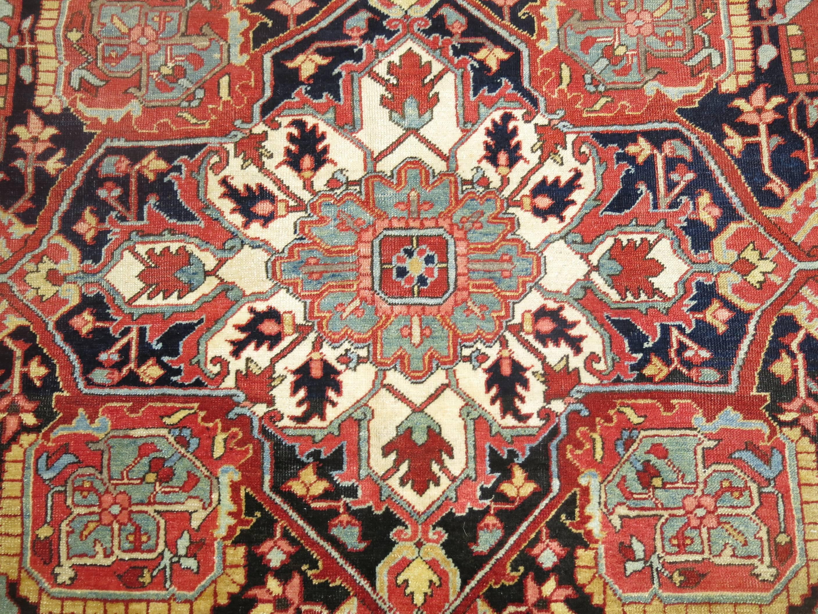 Rare square room size fine quality Persian Heriz Serapi rug with Classic central medallion on a red field and navy border entrenched by sky blue corners,

circa 1910, measures: 10'6