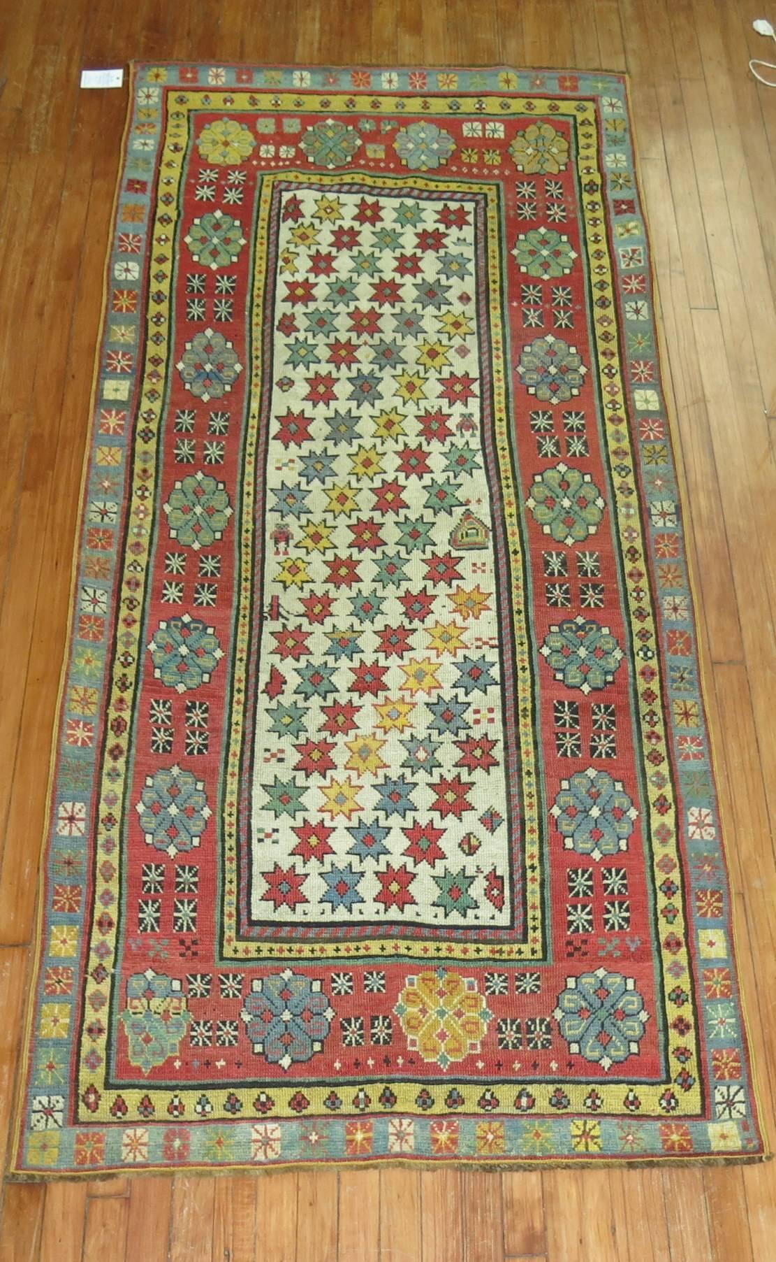 Colorful antique Caucasian Talish intermediate size runner. Small Star crossed all over design on an ivory ground, accents in soft red, coral, mustard and teal.

Measures: 3'8