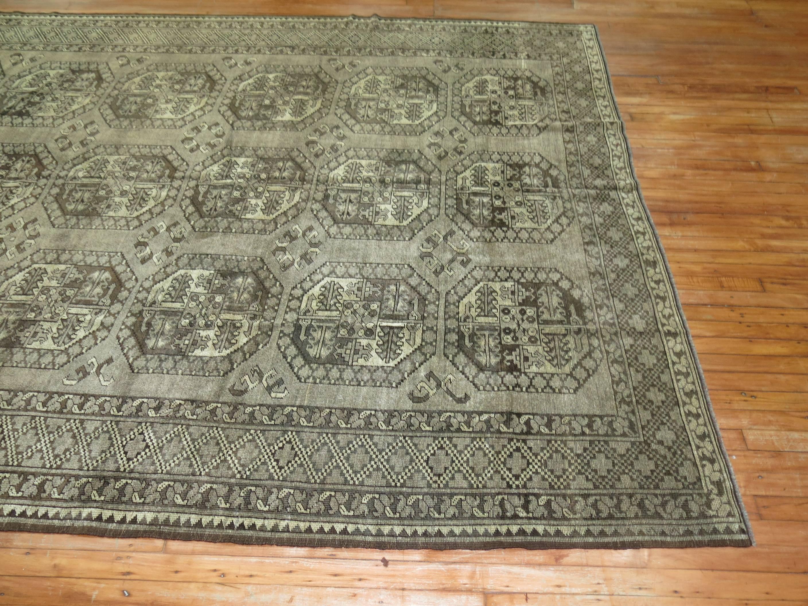 A rare room size Afghan Ersari rug in brown and gray. Usually found in 6 x 9 up to 8 x 10 size formats this one is a full room size piece.