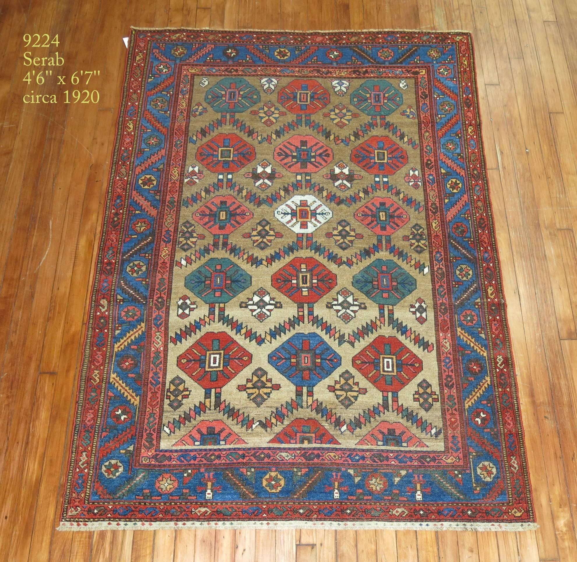 Primitive Persian Serab rug, camel colored field and light blue border highlight this great find.

Measures: 4'6'' x 6'7'' circa 1920.