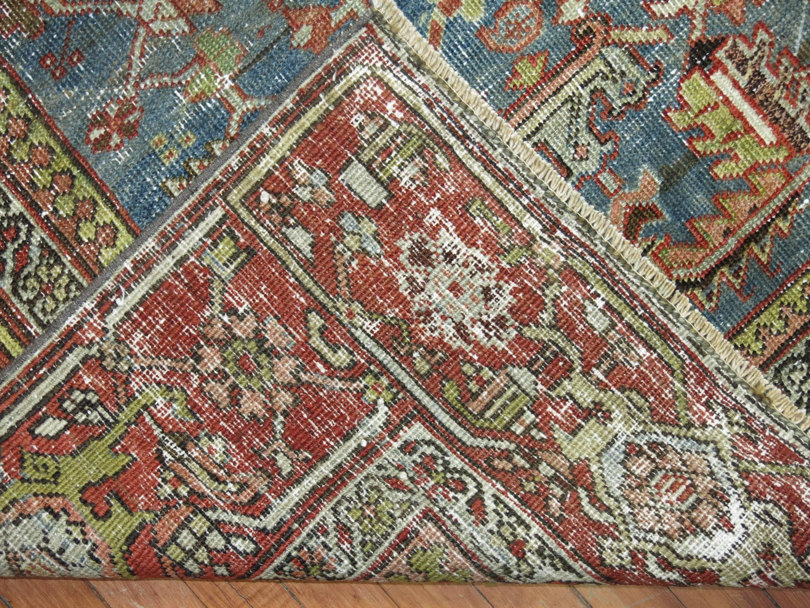 A shabby chic Persian Heriz textured rug,

circa 1920, measures: 6 x 9'5