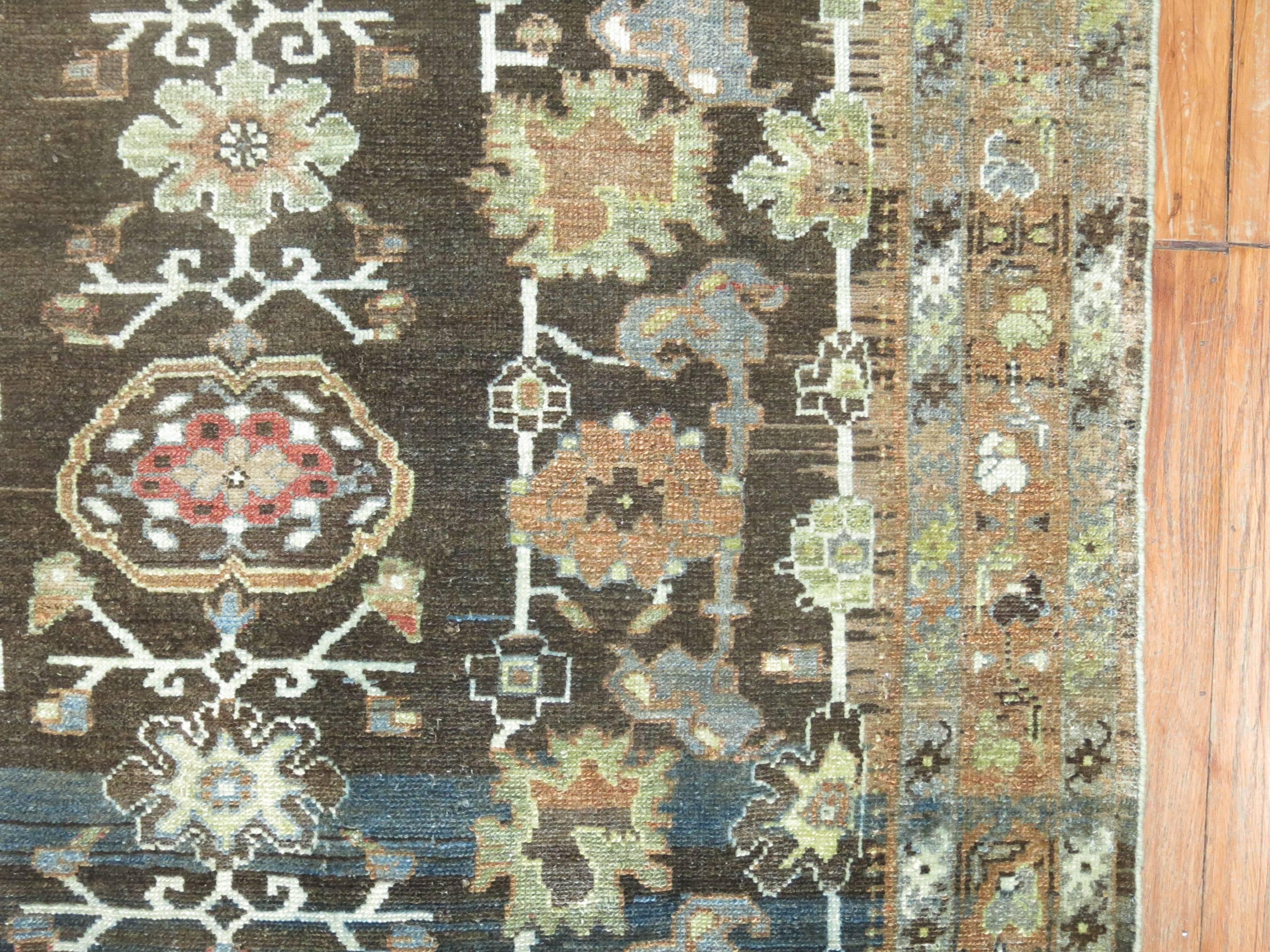 An antique Persian Malayer rug in earth tones.