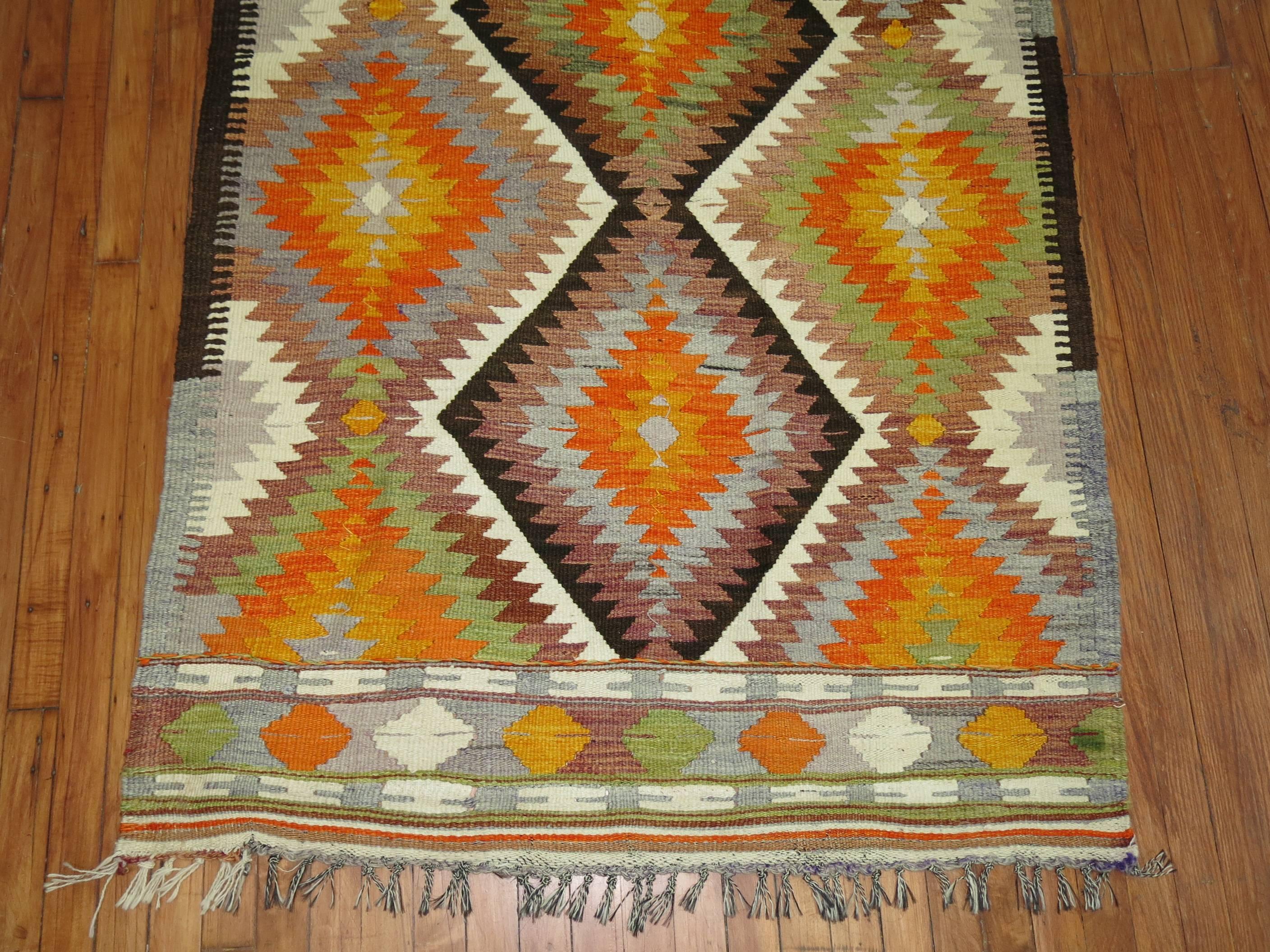 One of a kind Turkish Kilim featuring a bright orange color.