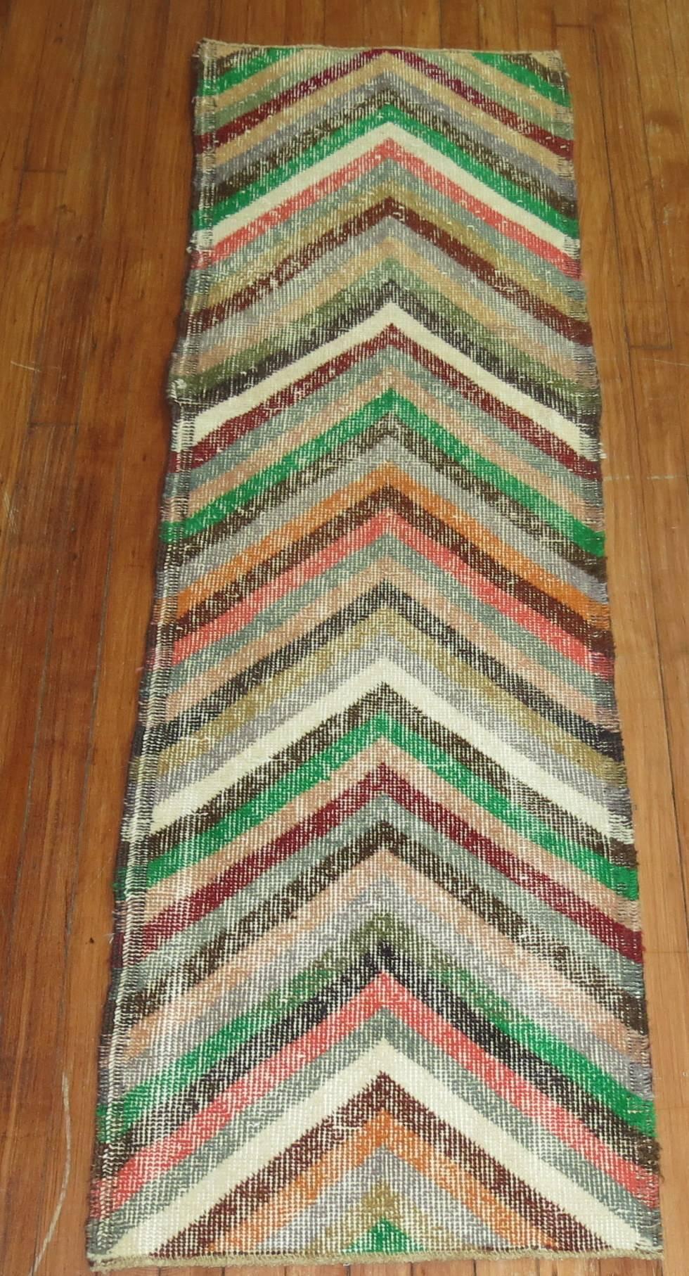 A colorful mid-20th century shabby chic Turkish runner.

Measures: 1'9” x 5'7”.