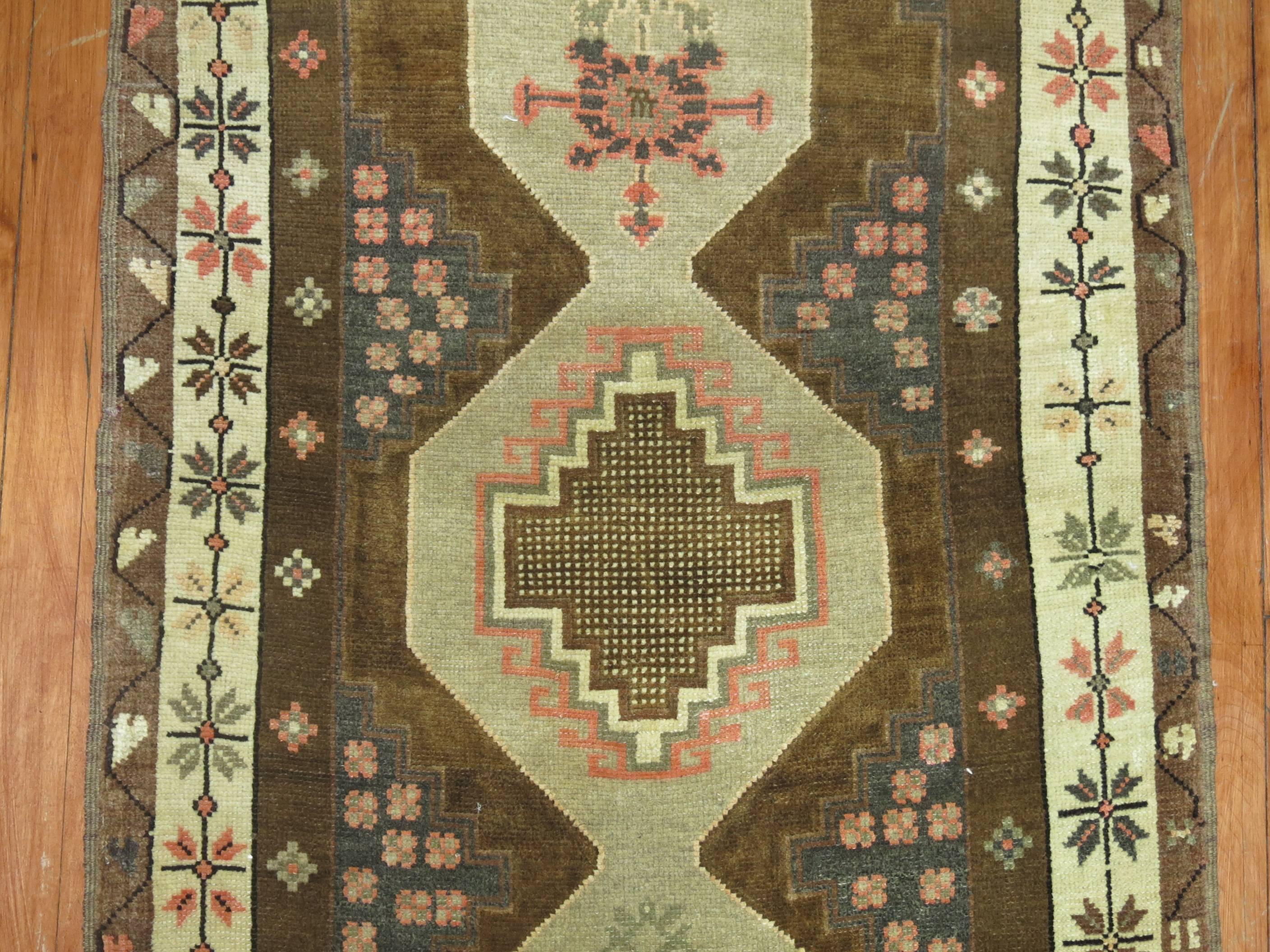 A vintage Turkish Oushak runner in predominantly brown with some accents in pink.
