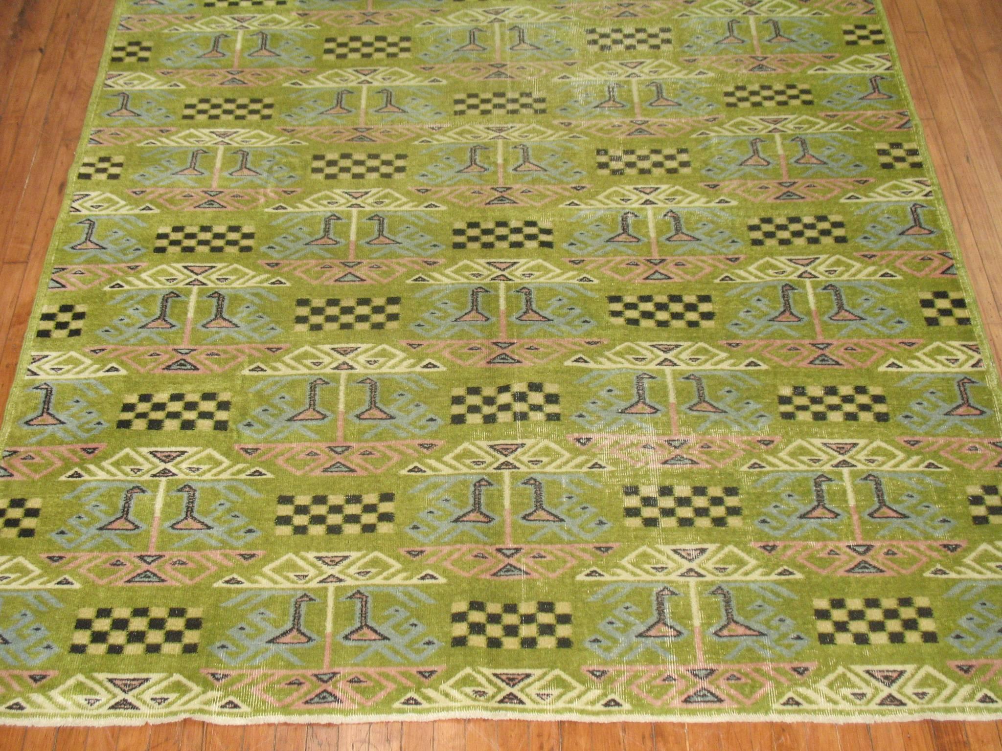 A vintage Turkish rug with an all-over swan motif on a lime green background.
