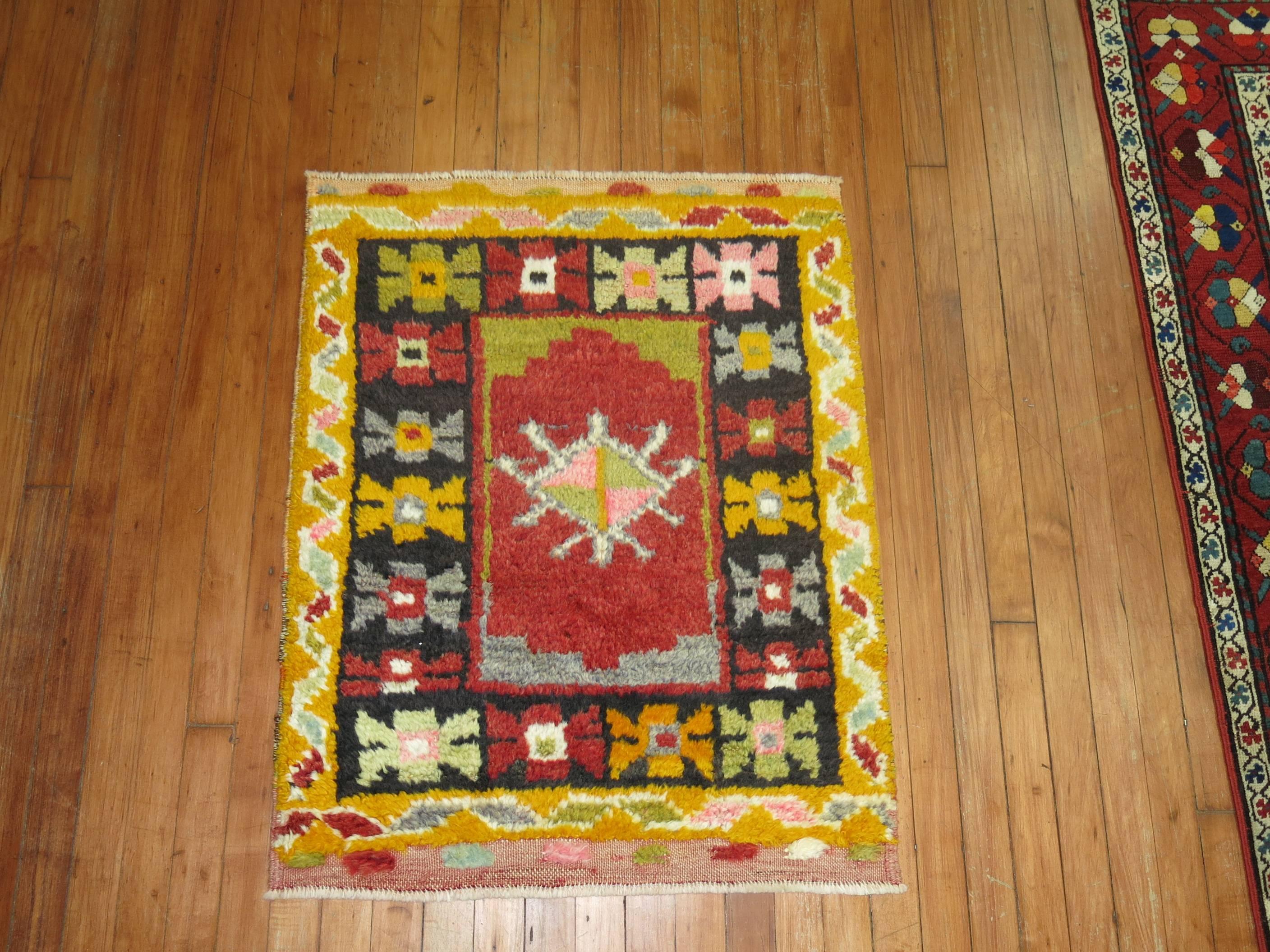 Turkish Konya small throw size square rug with a floral medallion and border design.