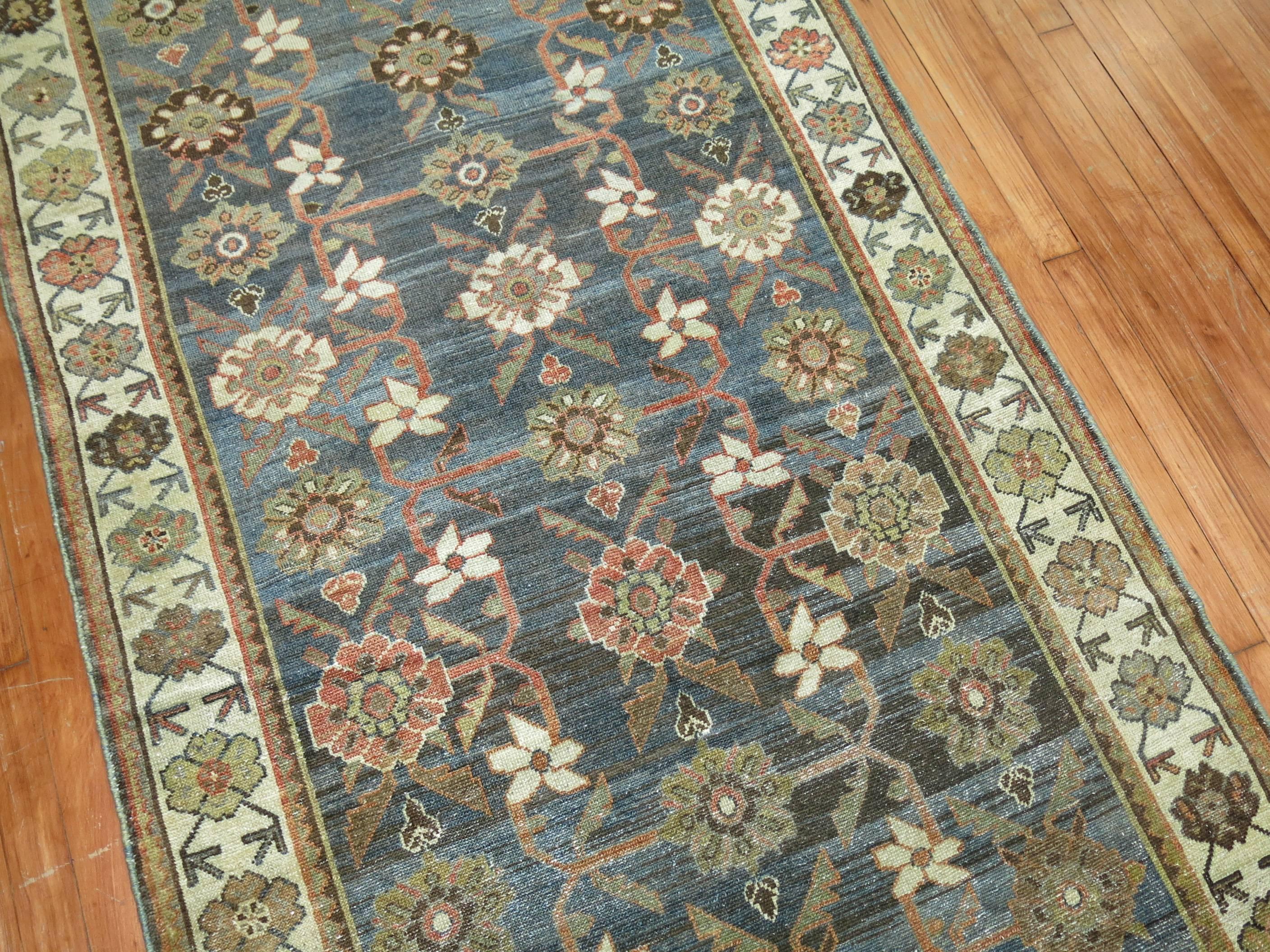 Stunning Persian Malayer Runner in earth tones from the 1920s. Pretty blues, gray, green and terracotta accents

Measures: 3'7” x 9'7”.