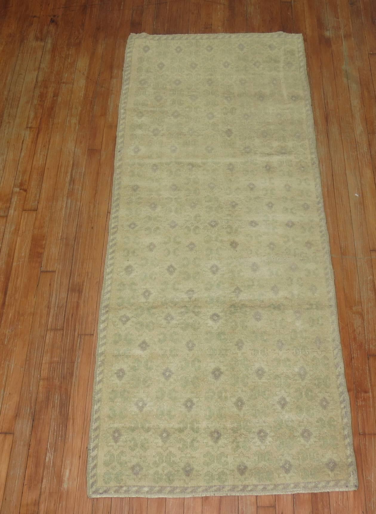 Vintage Turkish runner with an all-over floral design with gray and soft green accents on a beige ground,

circa mid-20th century, measures: 2'11