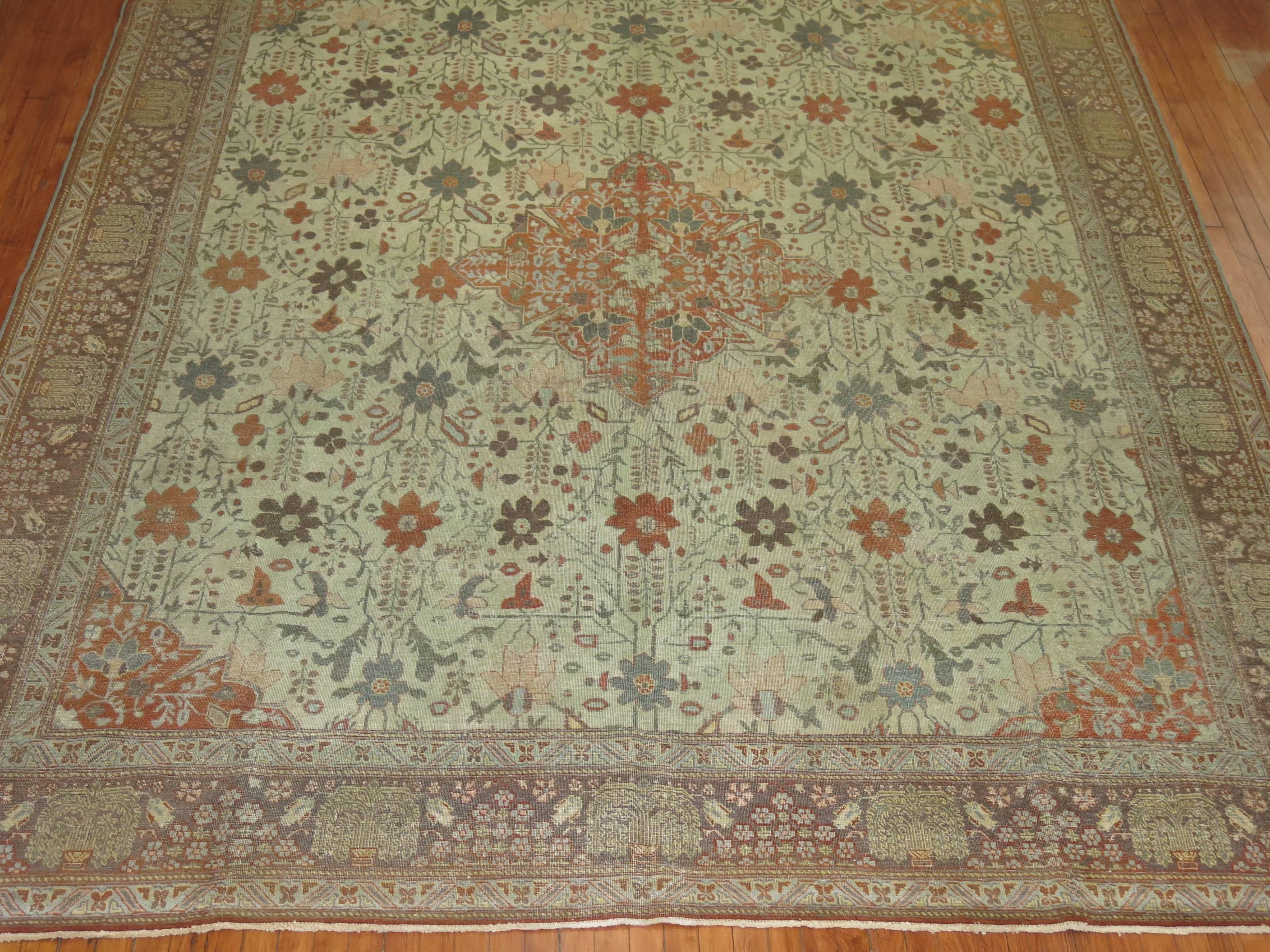 Tapis persan Tabriz du début du XXe siècle dans des tons terreux avec un motif rappelant l'automne.