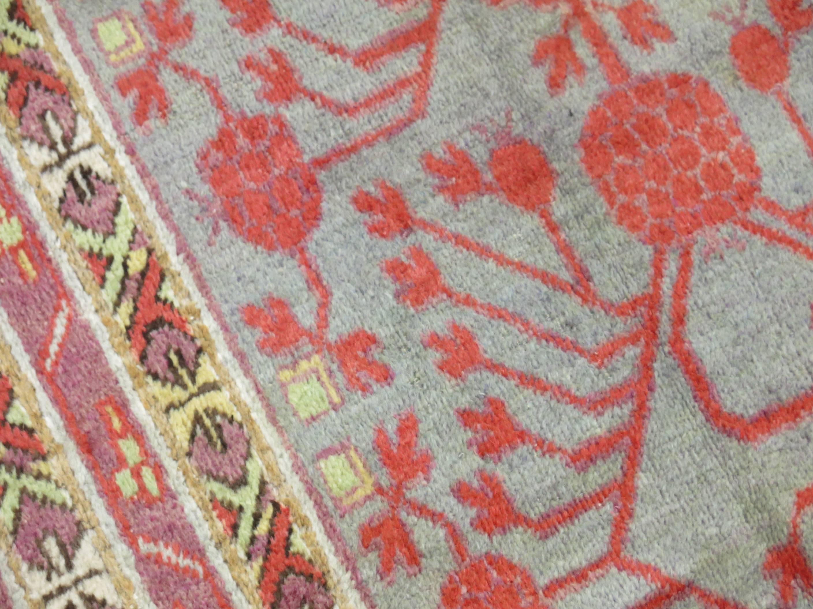 Hand-Woven Wool Early 20th Century Khotan Gray Field Red Pomegranate Full Pile Rug For Sale