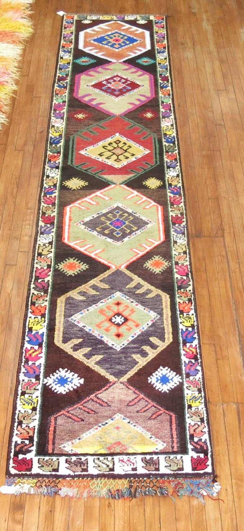 A colorful Turkish runner woven in central turkey. Even medium pile throughout.

2'9'' x 13'6''