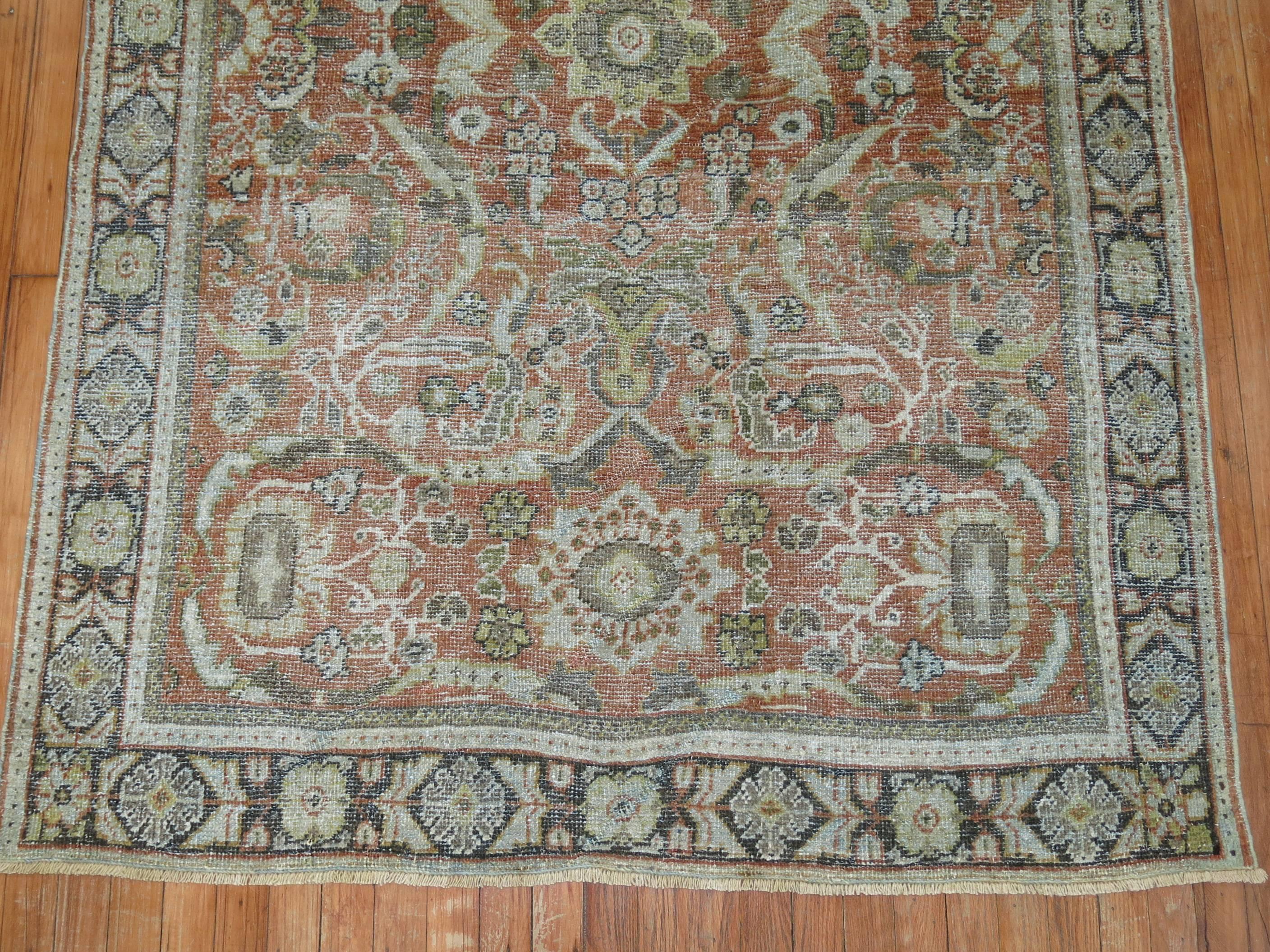 An early 20th century Persian Mahal weather appeal shabby chic rug in rustic tones. The field is terracotta, the border is a dark brown. Perfect for the shabby chic lover,

circa 1920, measures: 4'7