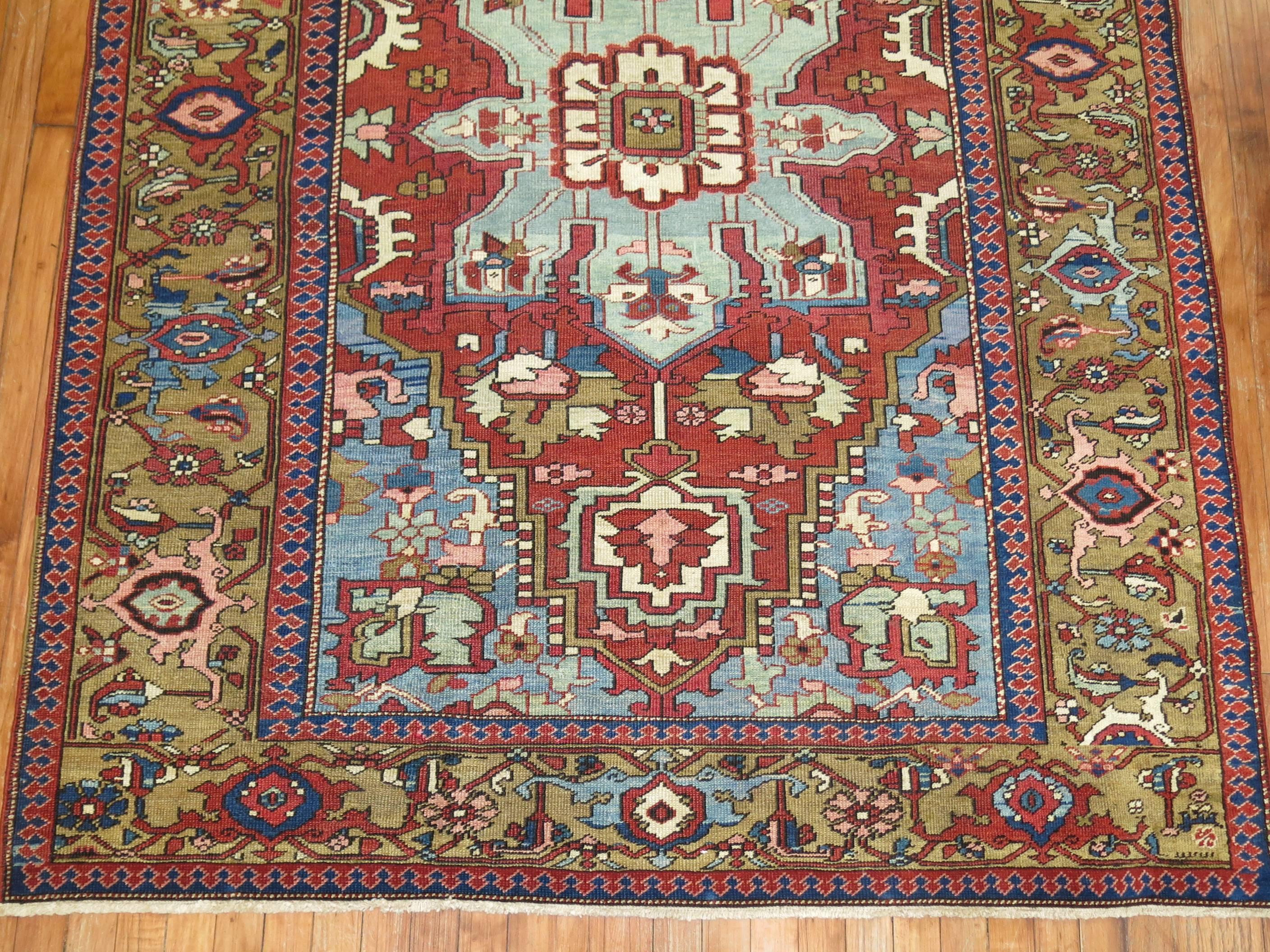 A rare size early 20th century Persian Serapi rug. Finely woven with Classic medallion and border. Dark rusty brown inner ground with a brown green caramel border and dominant accents in soft and denim blue. This quality on this piece is