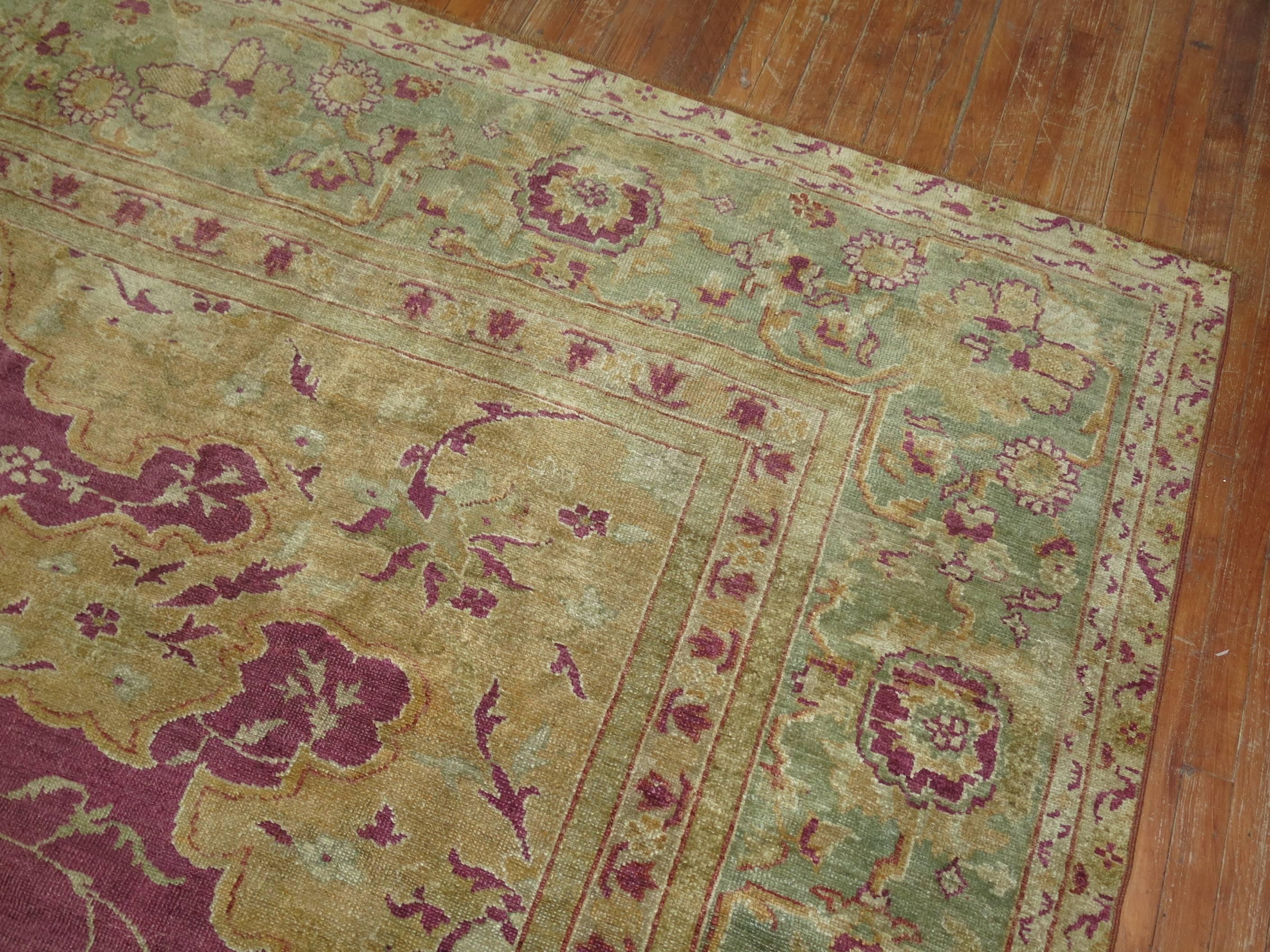 An early 20th century Turkish Ghiordes rug. Plum field, mint green medallion and border with gold accents.

Measures: 12'3'' x 15'7'' circa 1920

Since the beginning of their production in the 18th century, rugs from the Anatolian town, Ghiordes