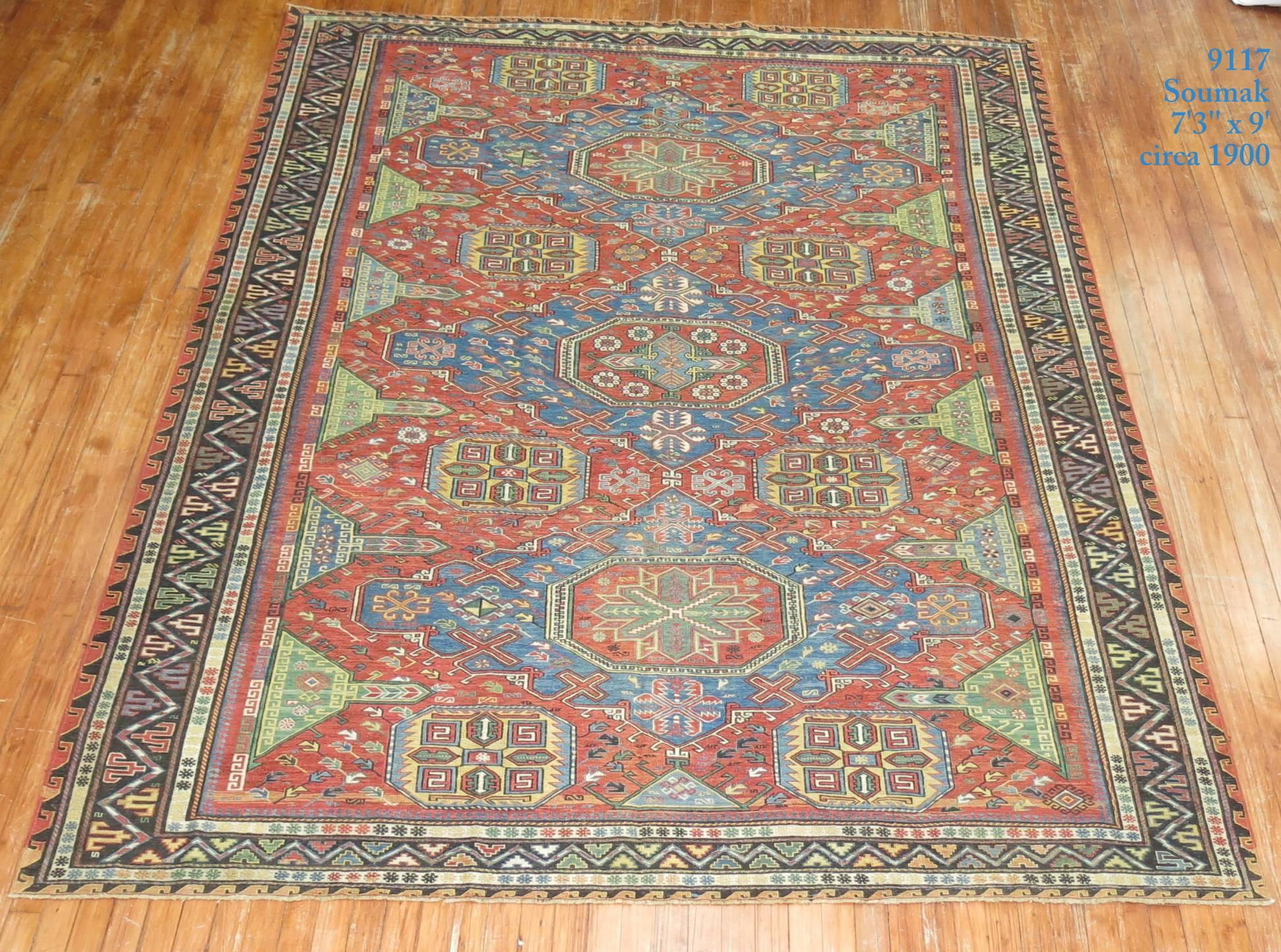 Breathtaking room size Soumak rug acquired from a private collection in NYC. Highlighted by lovely blues and green on a rusty red ground.

Soumak rugs have a construction technique that produce a flat-weave rug that is relatively thick, strong and