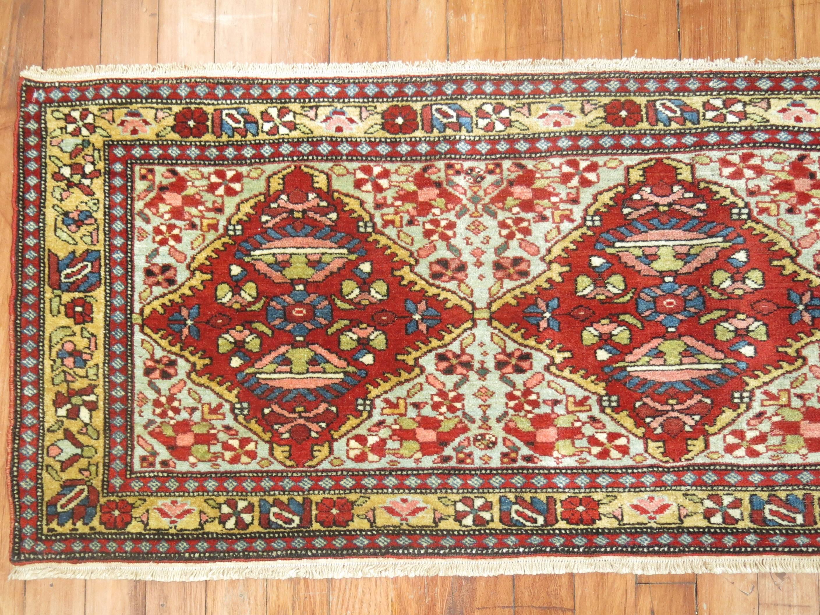 An early 20th century horizontally handwoven Persian Malayer rug with a green field, accents in red and gold

Measures: 1'7