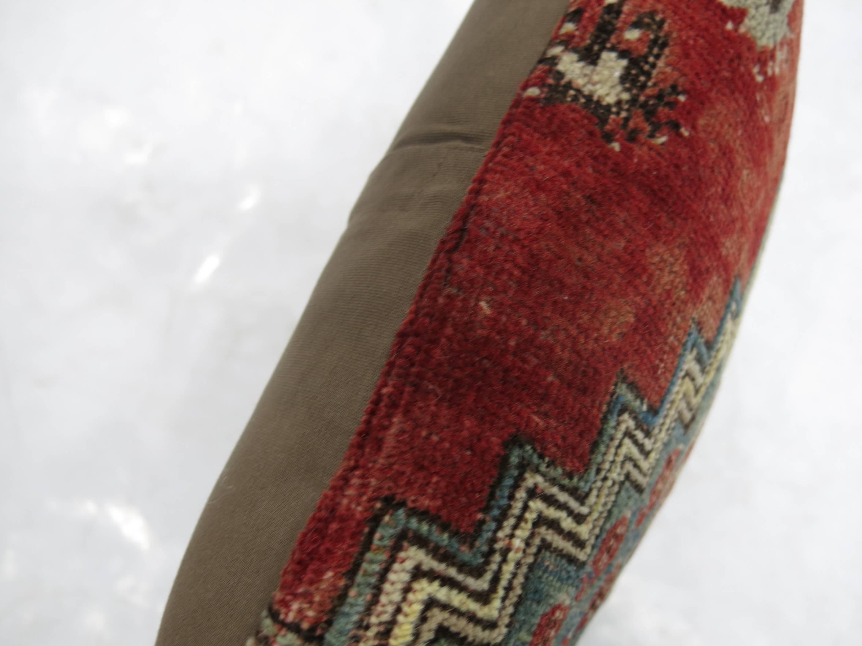 Pillow made from a vintage Turkish rug in reds and blues

15'' x 19''