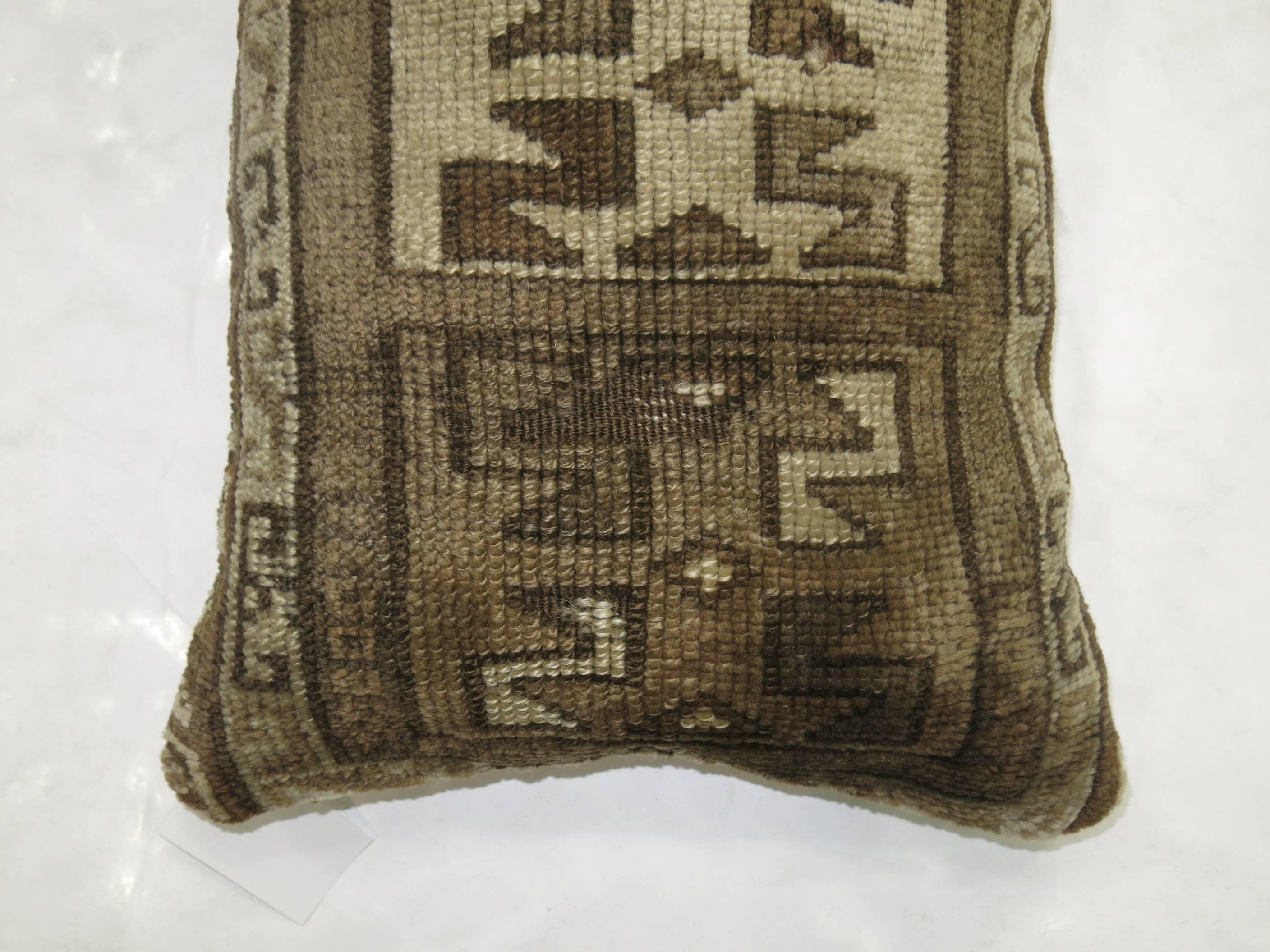 Pillow made from a vintage Turkish kars rug with a tribal motif in brown

17'' x 24''