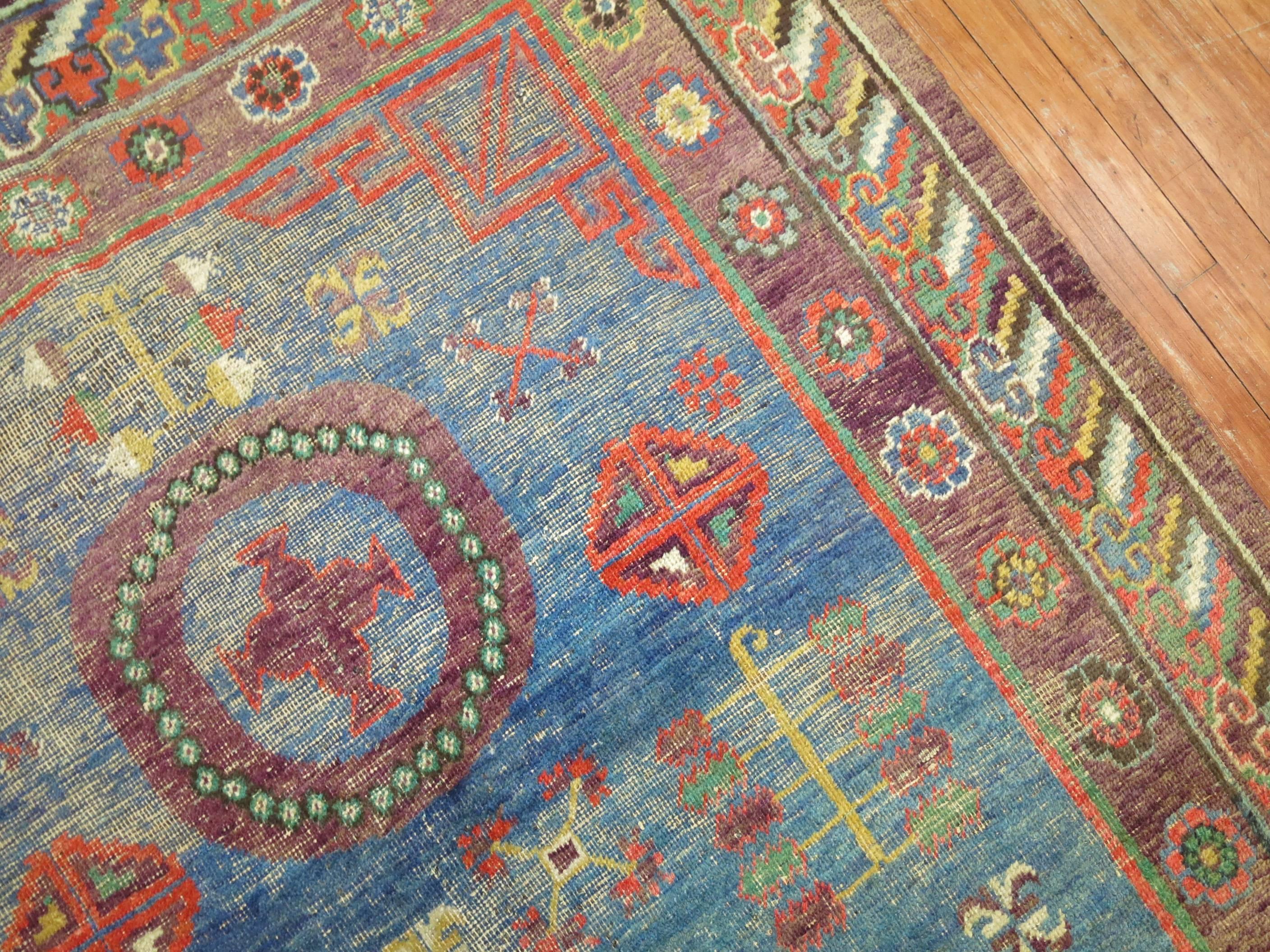 An early 20th century Khotan rug with a denim blue field.

Measures: 5'3