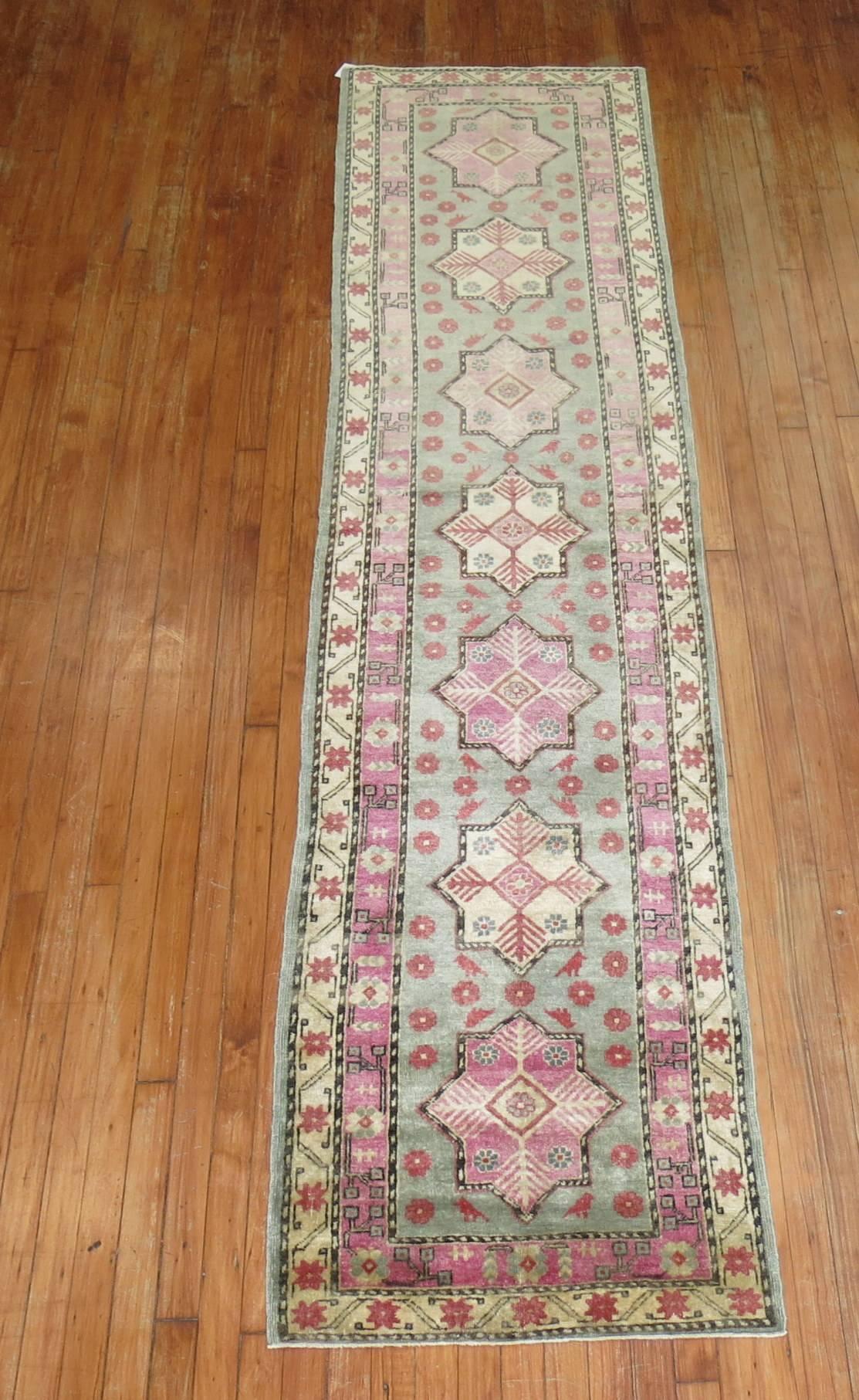 Rare Khotan runner in lovely shades in pink and mint green.

Khotan rugs hail from East Turkestan. Due to its geographical proximity to both Persian and China, Khotan rugs feature predominantly stylized geometric arrangements of traditional