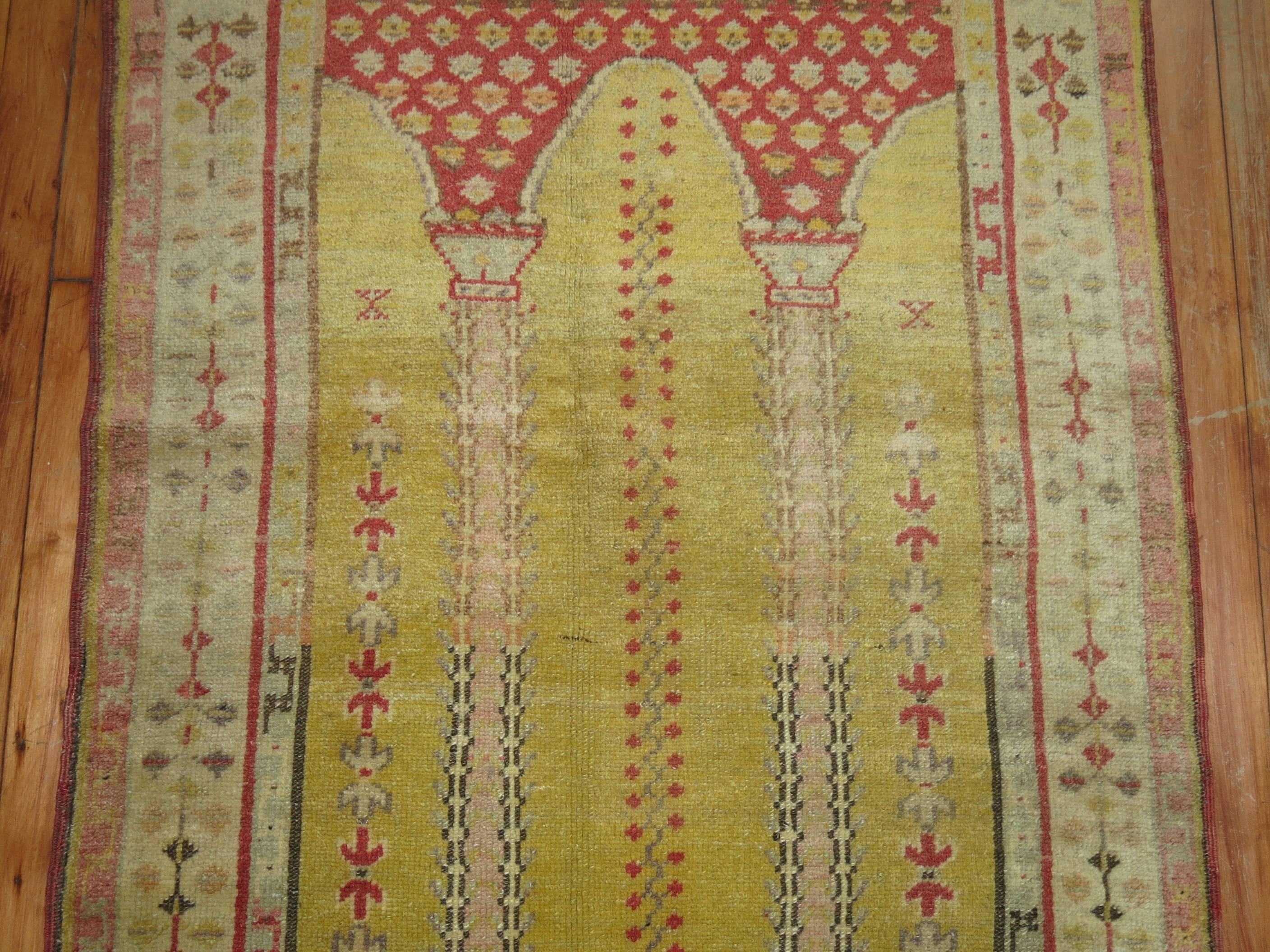 Highly decorative Turkish rug with a double column prayer niche design on a sunny yellow ground, circa 1920.

Measures: 2'11