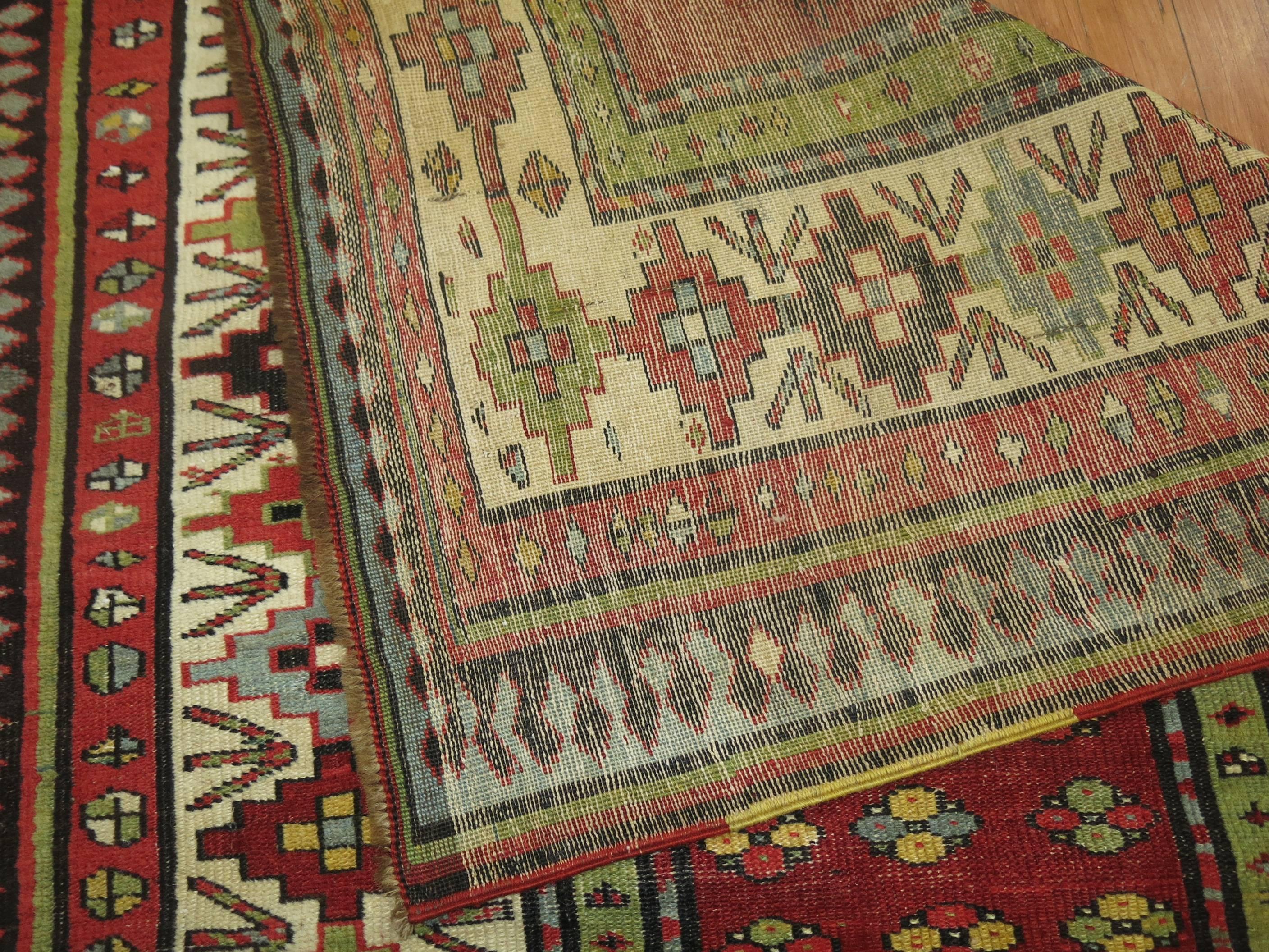 Lovely Caucasian Talish runner from the late 19th century in earth red, blue ivory red and yellow accents. The colorful side cords were added by the weaver too to give it more of a unique character,

circa 1900, measures: 3'5