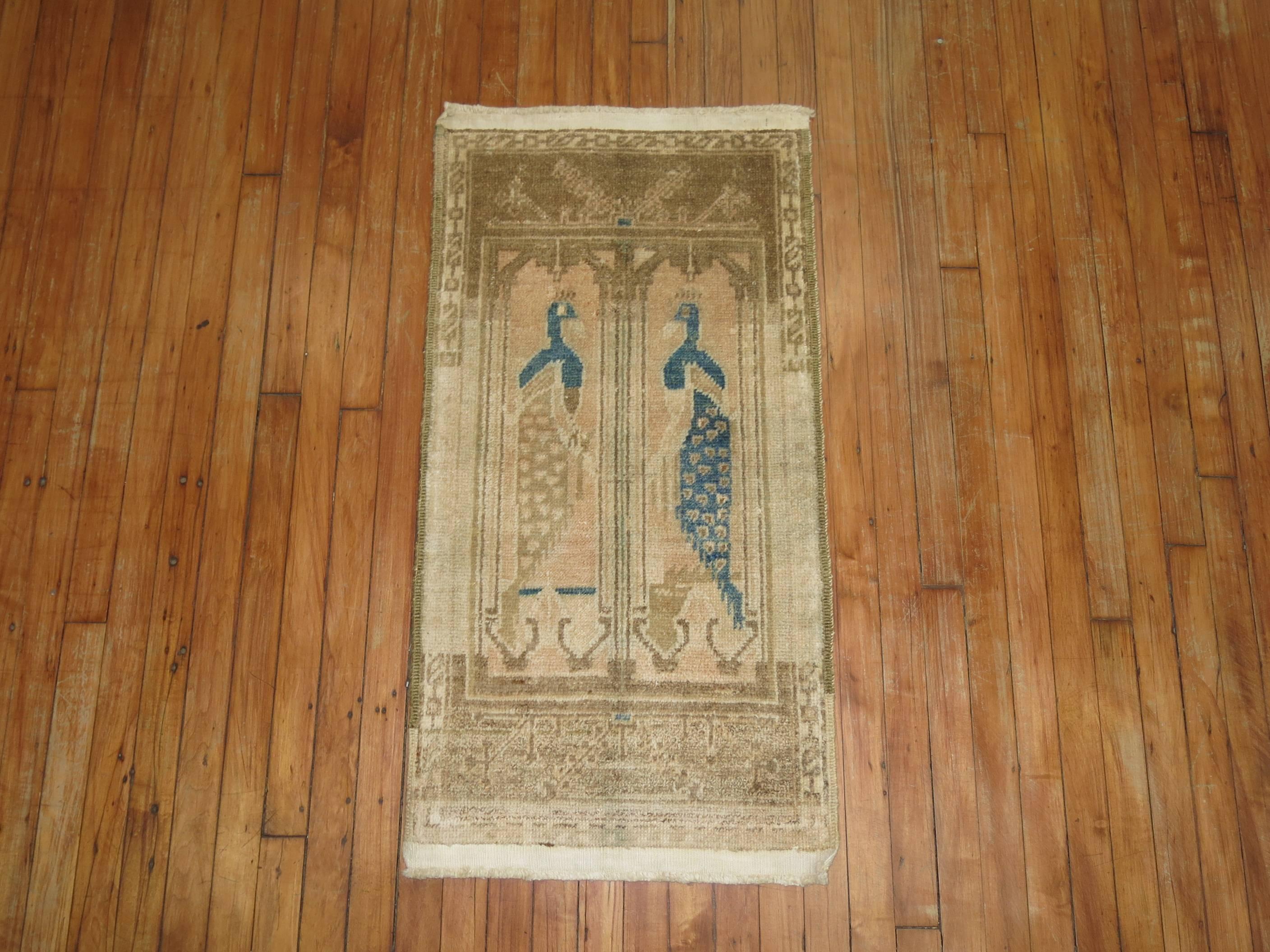 One of a kind Turkish rug with what looks to be two pigeons facing each other.