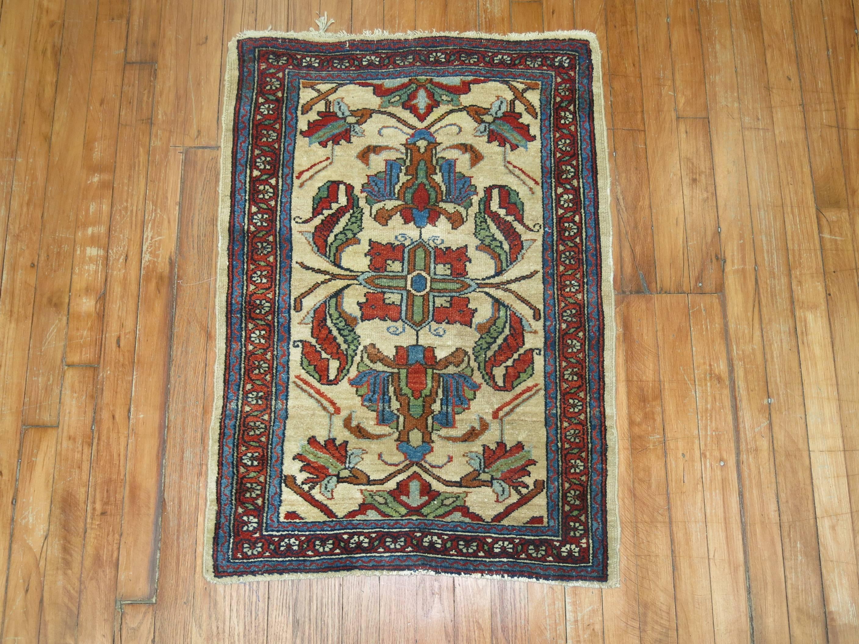 An early 20th century finely decorative Persian rug. Ivory bone field, accents in red rust and green,

circa 1910, measures: 2'3