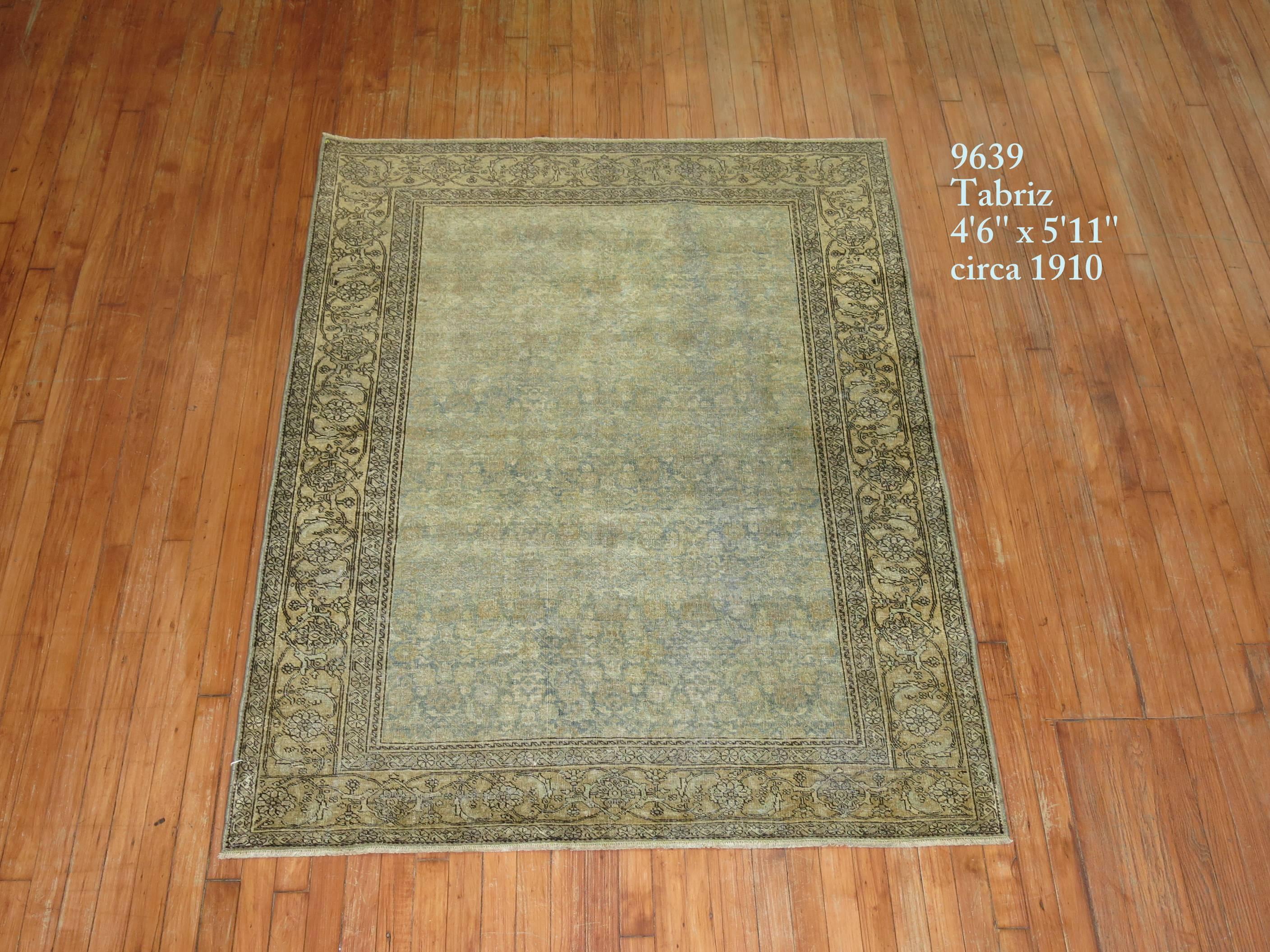 An early 20th century antique Persian Tabriz rug. Blue field, yellow border.